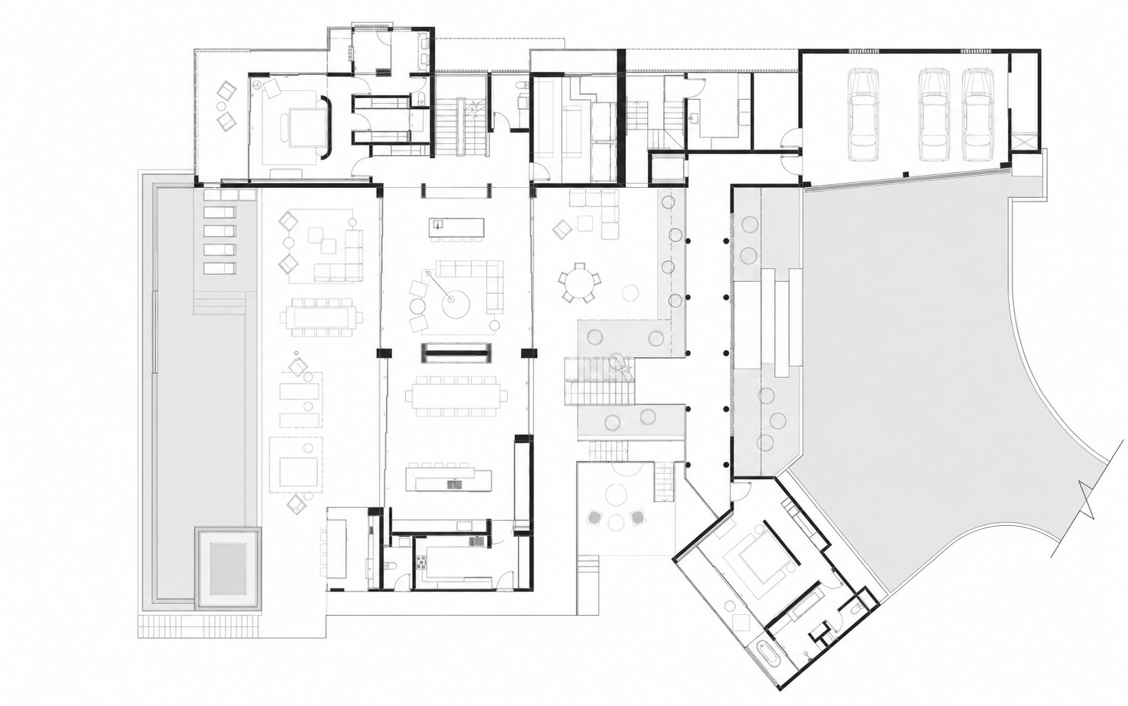 Floor plan drawing showing open living spaces with pool terrace and angled wing containing garage