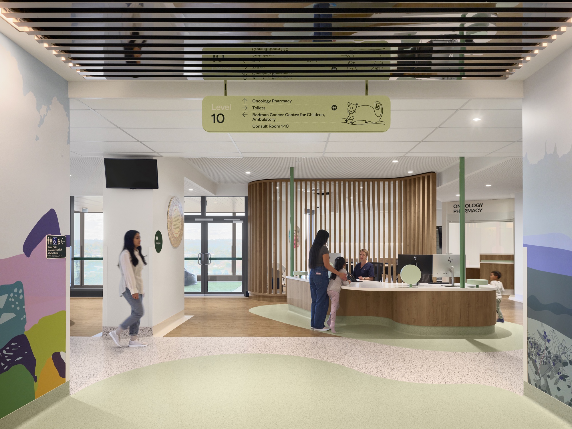 Reception area with curved timber slat screen and terrazzo flooring with visitors at the desk