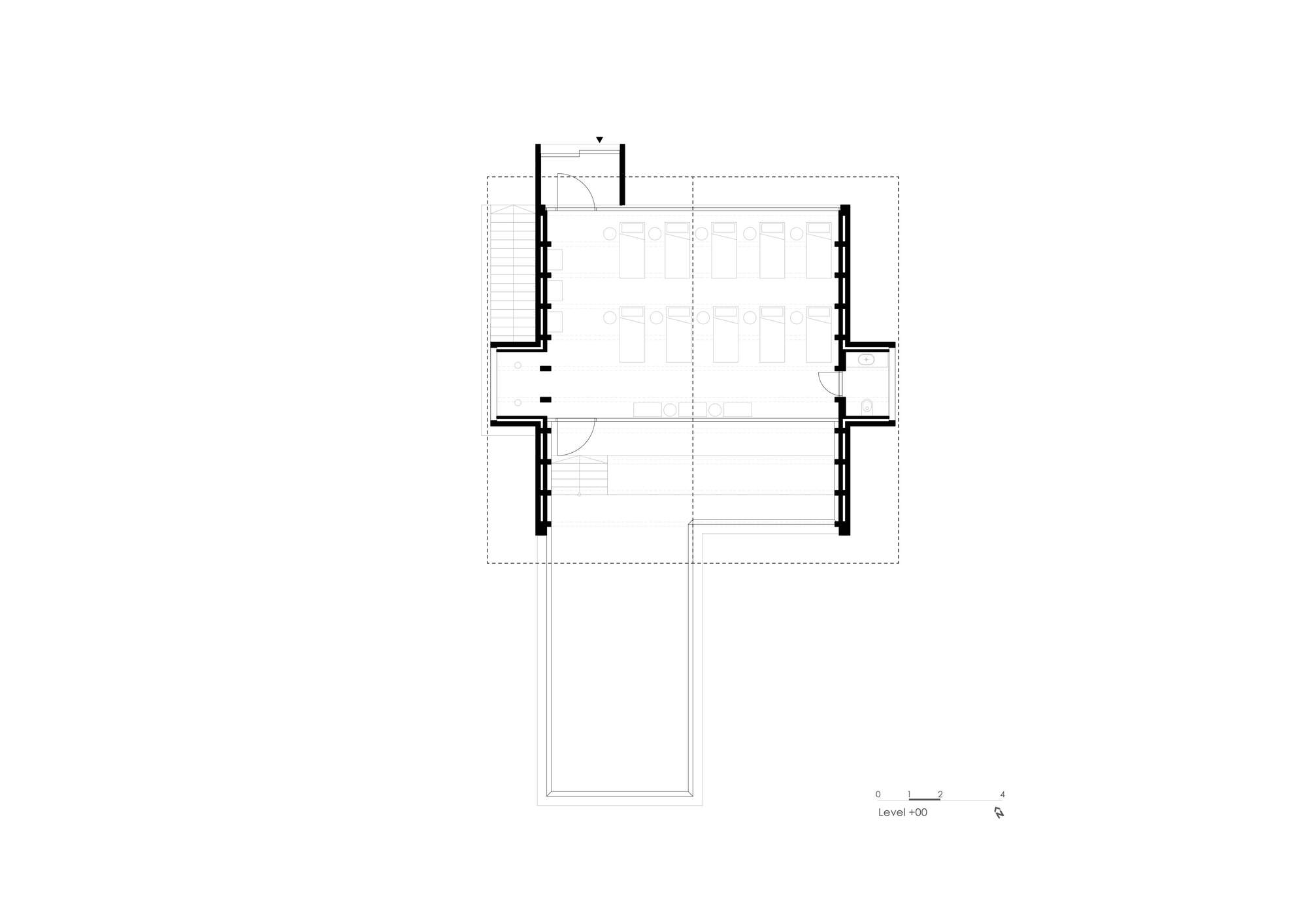 Floor plan drawing of an open interior with thick perimeter walls and central stair
