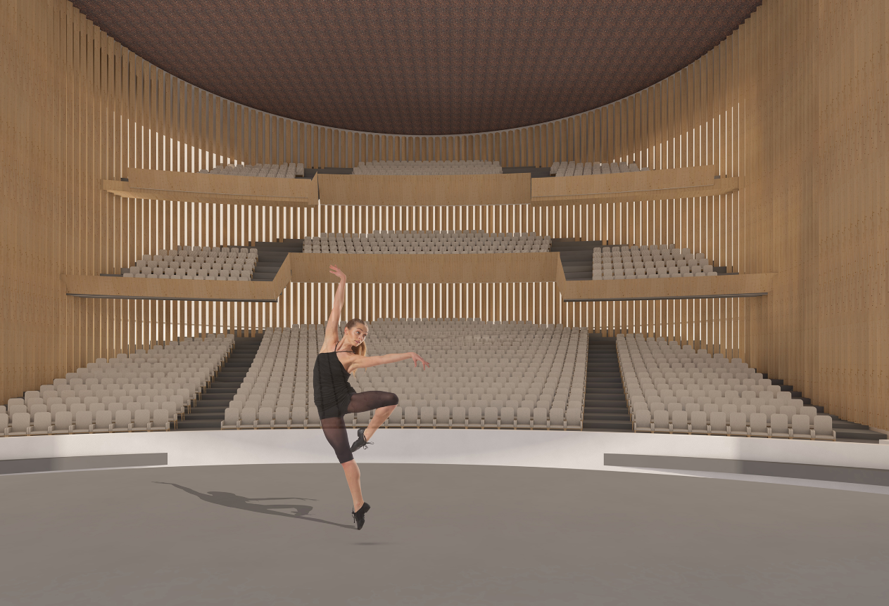 Interior view of tiered seating with vertical timber battens and a dancer performing on the stage below