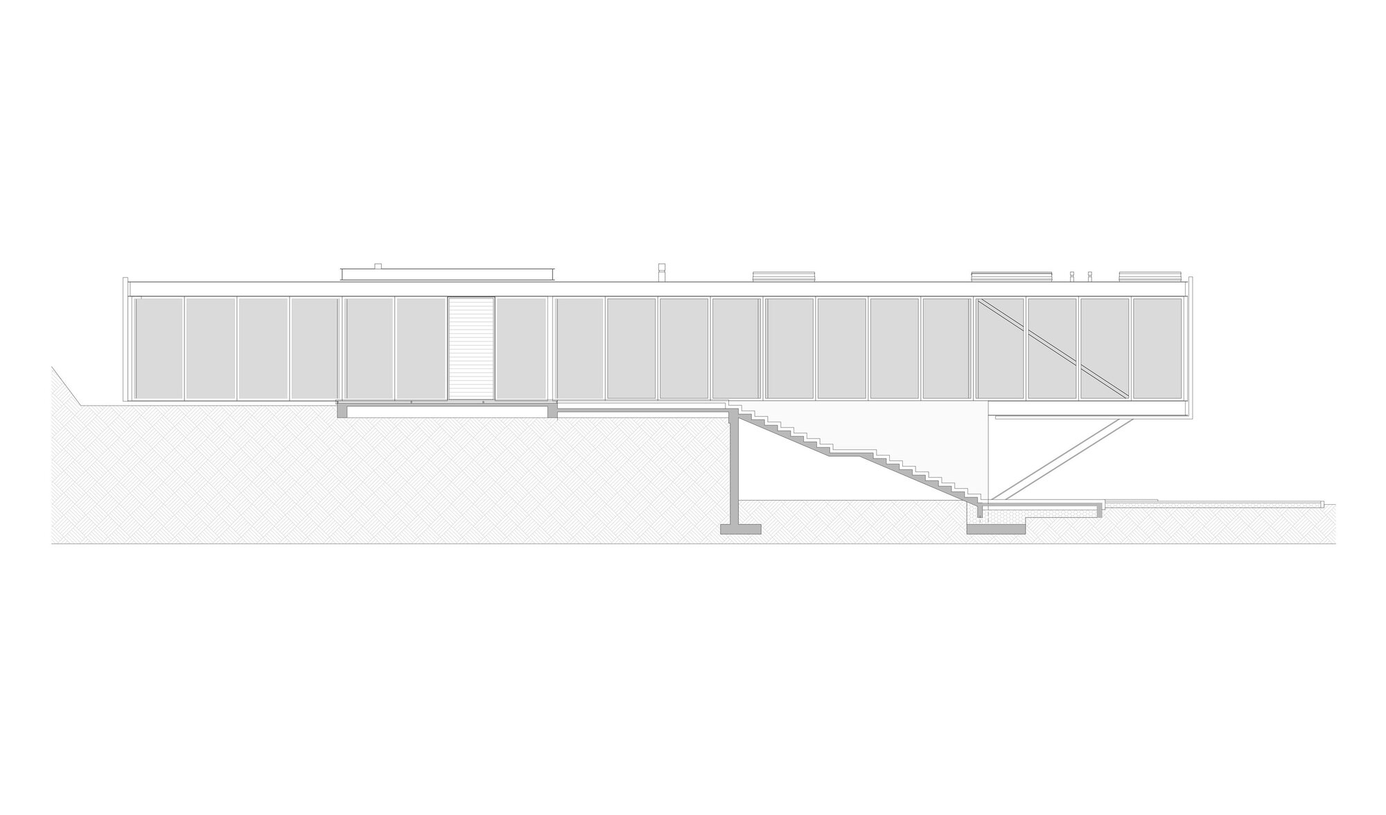 Section drawing showing a linear pavilion with exterior stairs descending the slope and vertical panel cladding