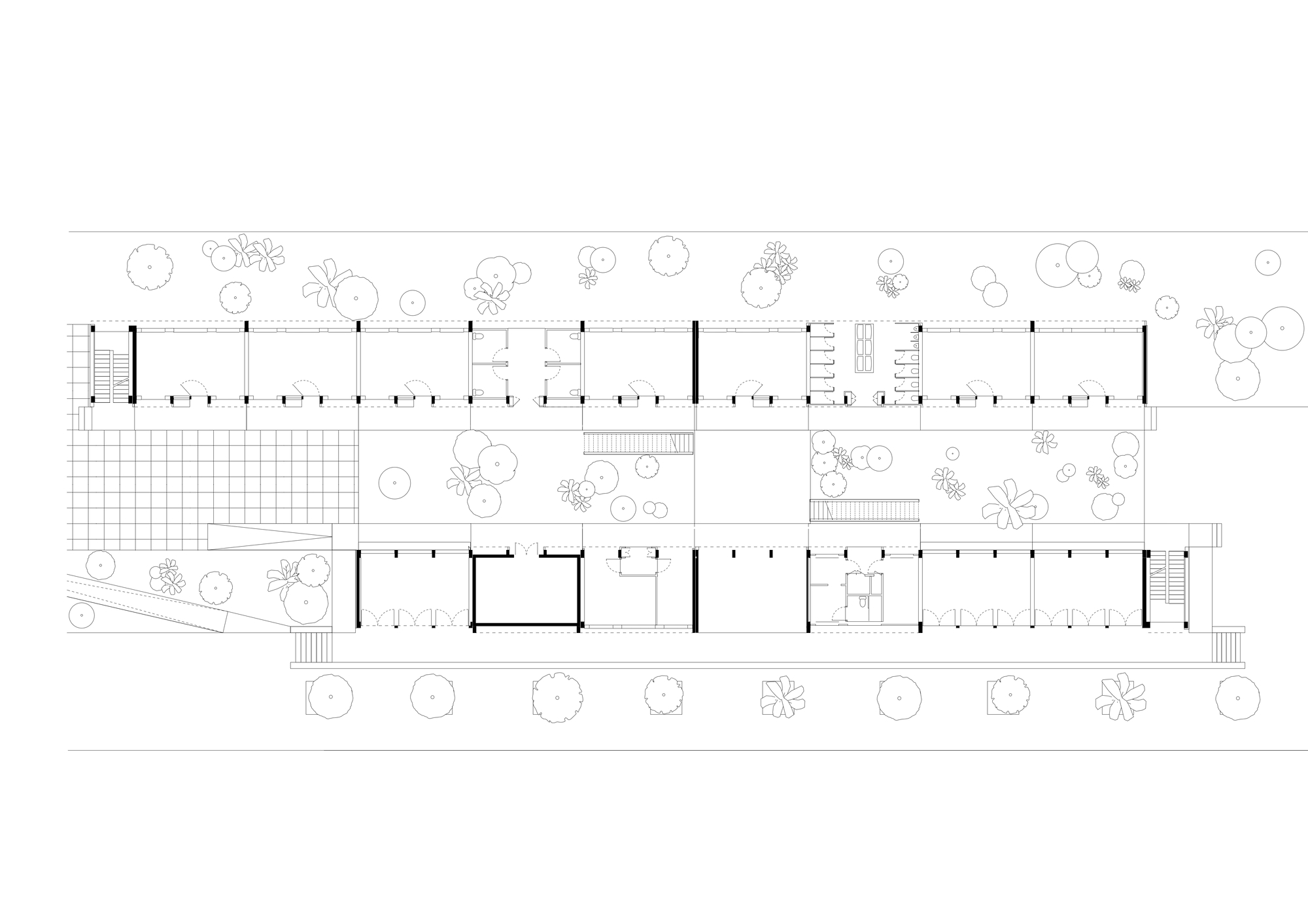 Ground floor plan drawing of two parallel classroom wings divided by a planted courtyard, with stairs, toilet cores and scattered trees