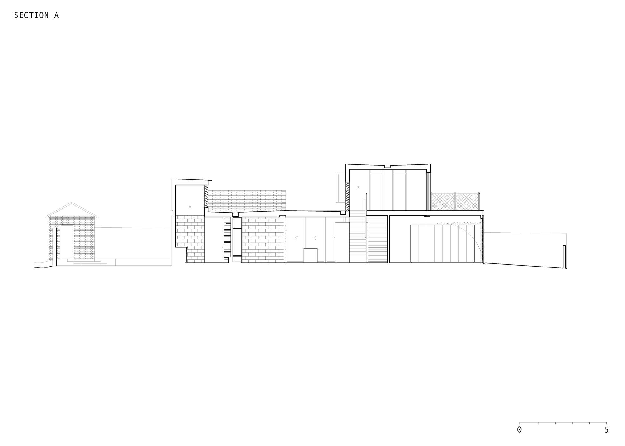 Section A drawing cutting through a low brick outbuilding, masonry walls, a stair, a garage door and a raised upper volume