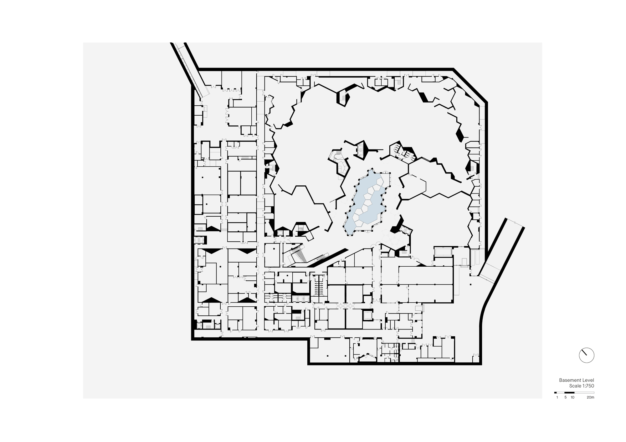 Basement level plan drawing showing service rooms around the perimeter and a central cluster of irregular galleries with a small pool