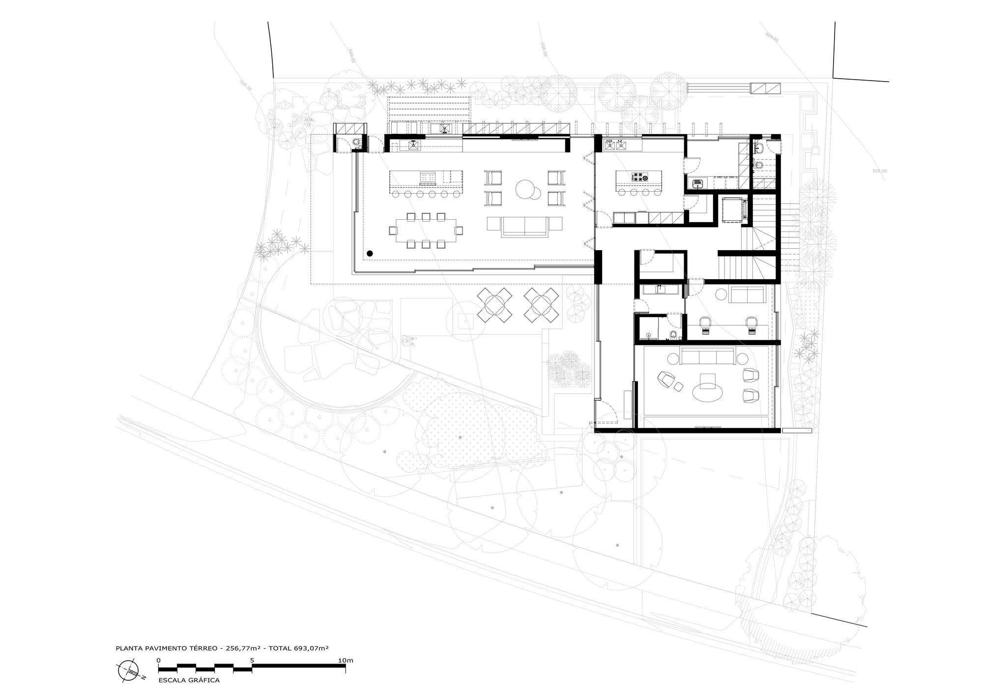 Ground floor plan drawing showing a large living and dining wing, kitchen, bedrooms and landscaped garden with scattered trees