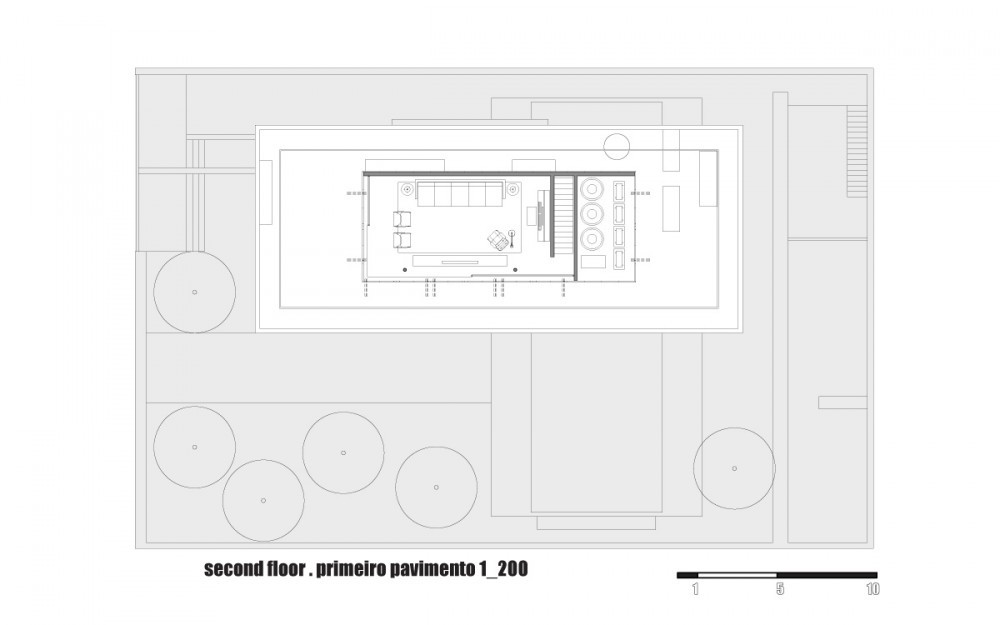 Second floor plan drawing showing a small rooftop living pavilion with furniture and a stair, surrounded by a terrace and circular tree outlines
