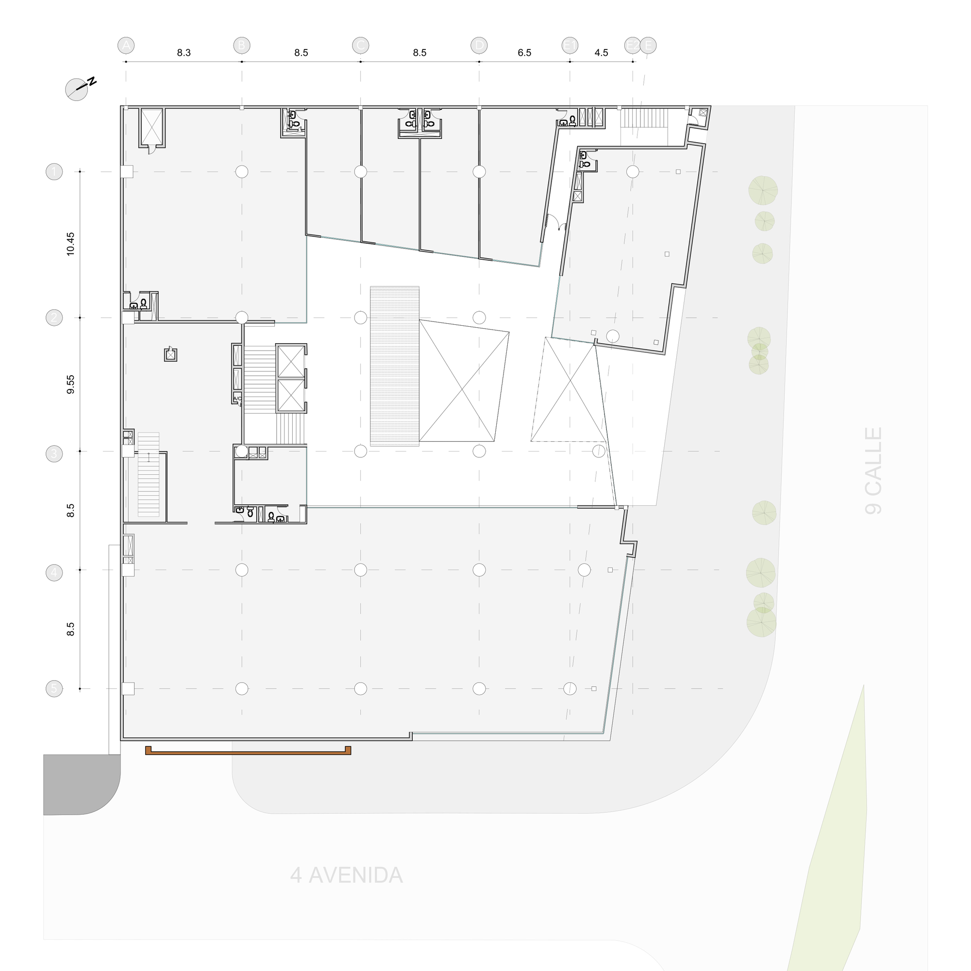 Upper floor plan drawing with a large open floor area wrapped around a central void with skylight crosses and a service core