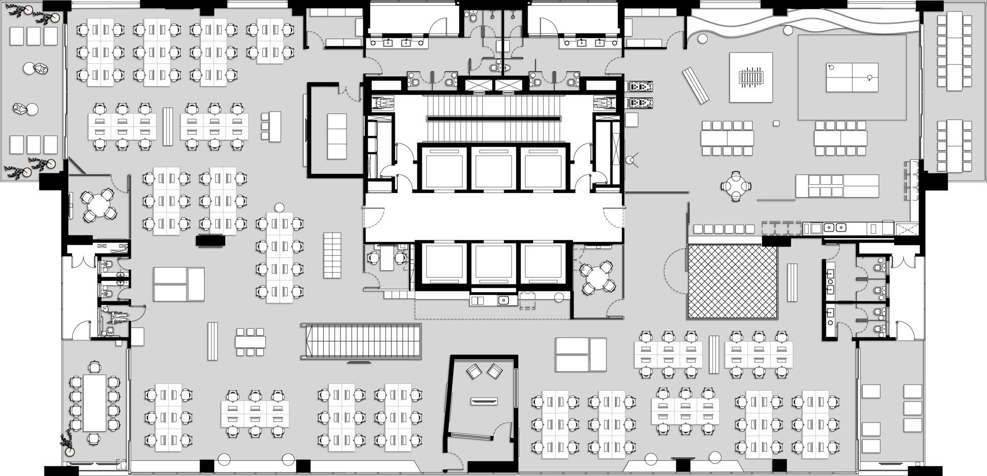 Floor plan drawing of an office level with a central elevator core surrounded by desk clusters, meeting rooms and a stair