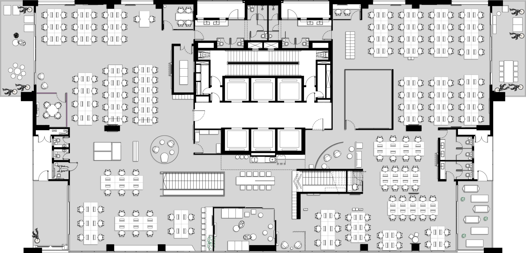 Floor plan drawing of an office level with rows of desks around a central core of lifts and a stair