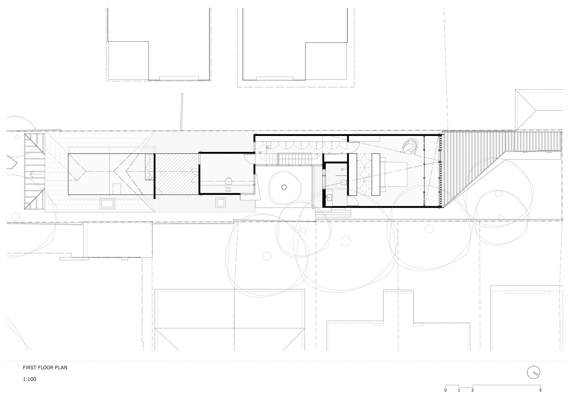 First floor plan drawing of a narrow house, showing a stair, a bedroom volume and pitched roofs below on the long site