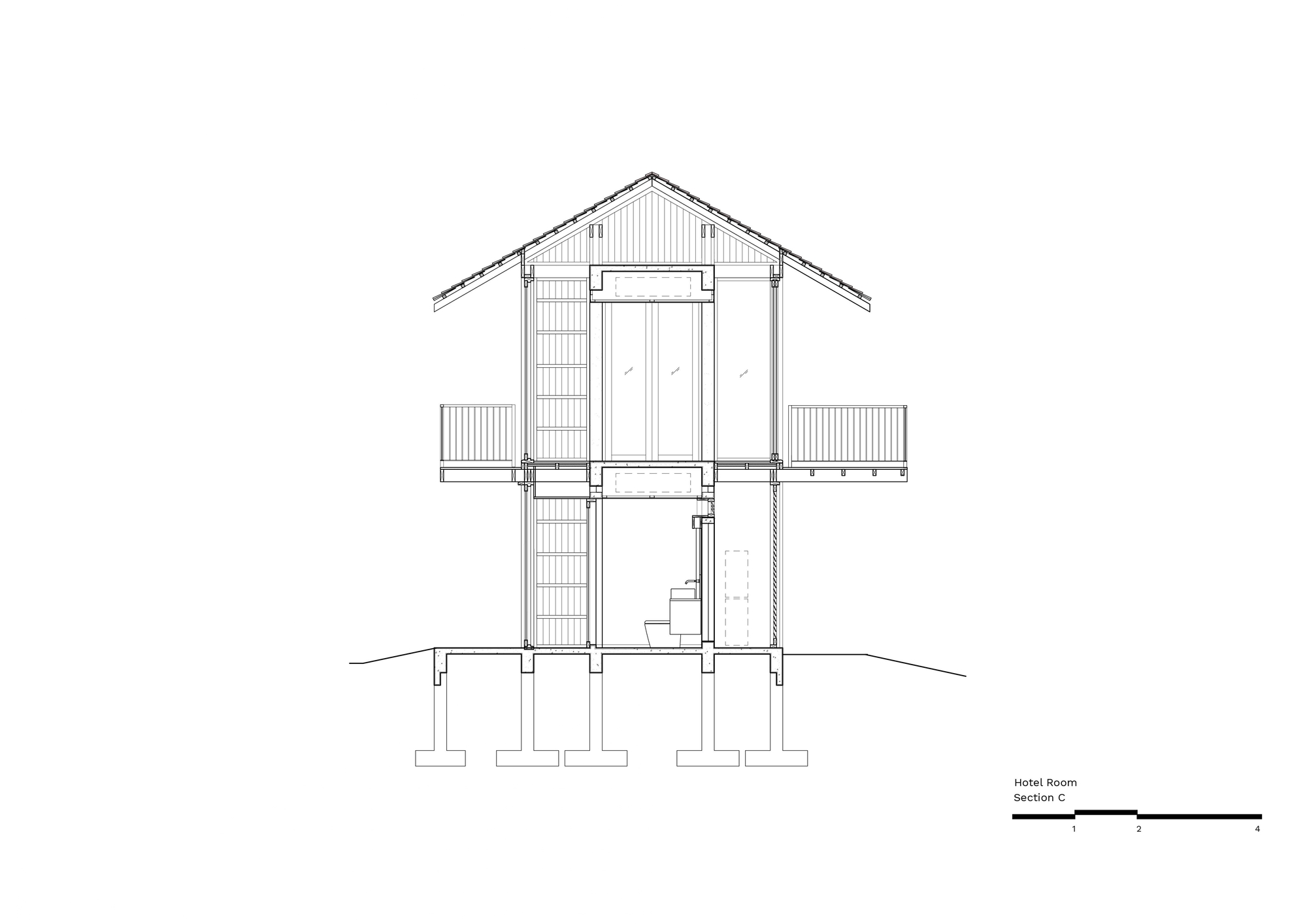 Building section drawing across the gabled room, cutting through a bathroom, balconies on both sides and concrete footings below
