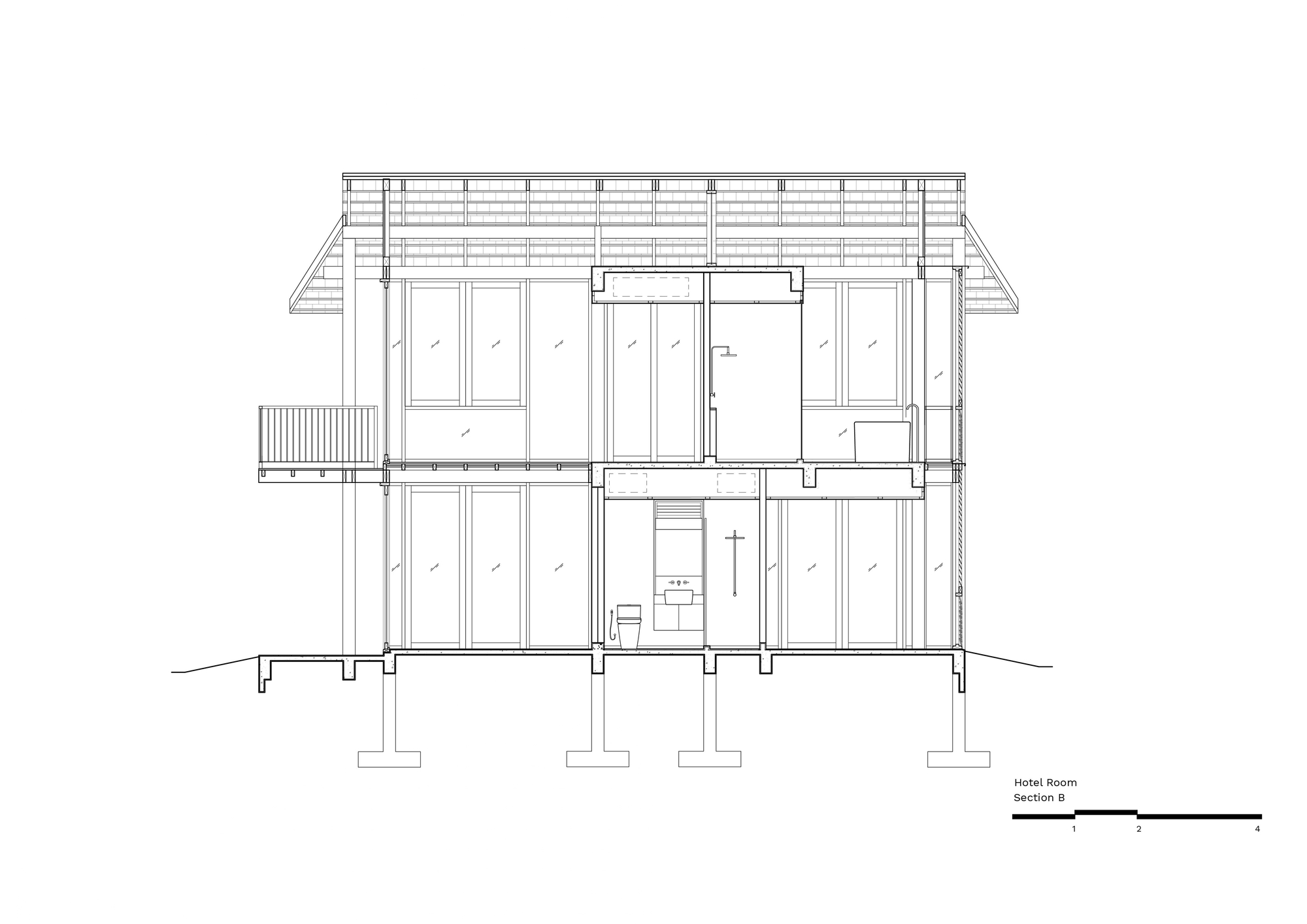 Building section drawing along the long axis, showing glazed bays, a shower and toilet core, a balcony and footings under a shingled roof