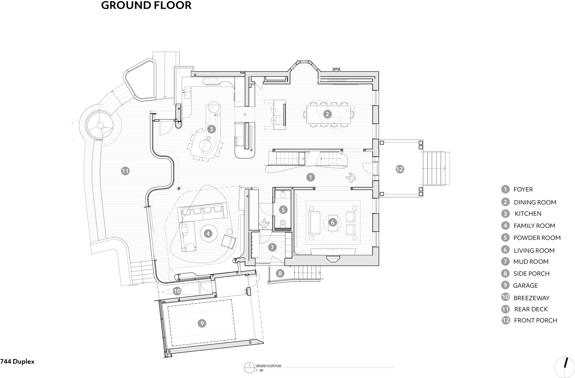 Ground floor plan drawing showing foyer, dining room, kitchen, living room and family room around a central stair, with a curved rear deck and detached garage