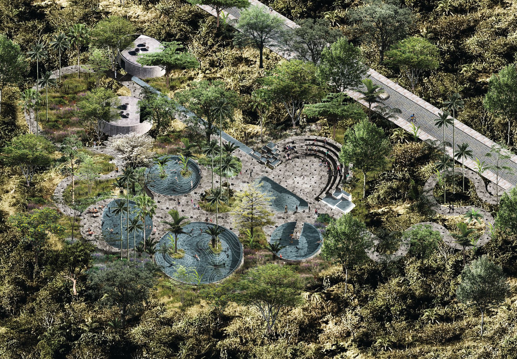 Oblique aerial view of round pools, a tiered amphitheatre and curving stone paths among palms and dense tropical trees