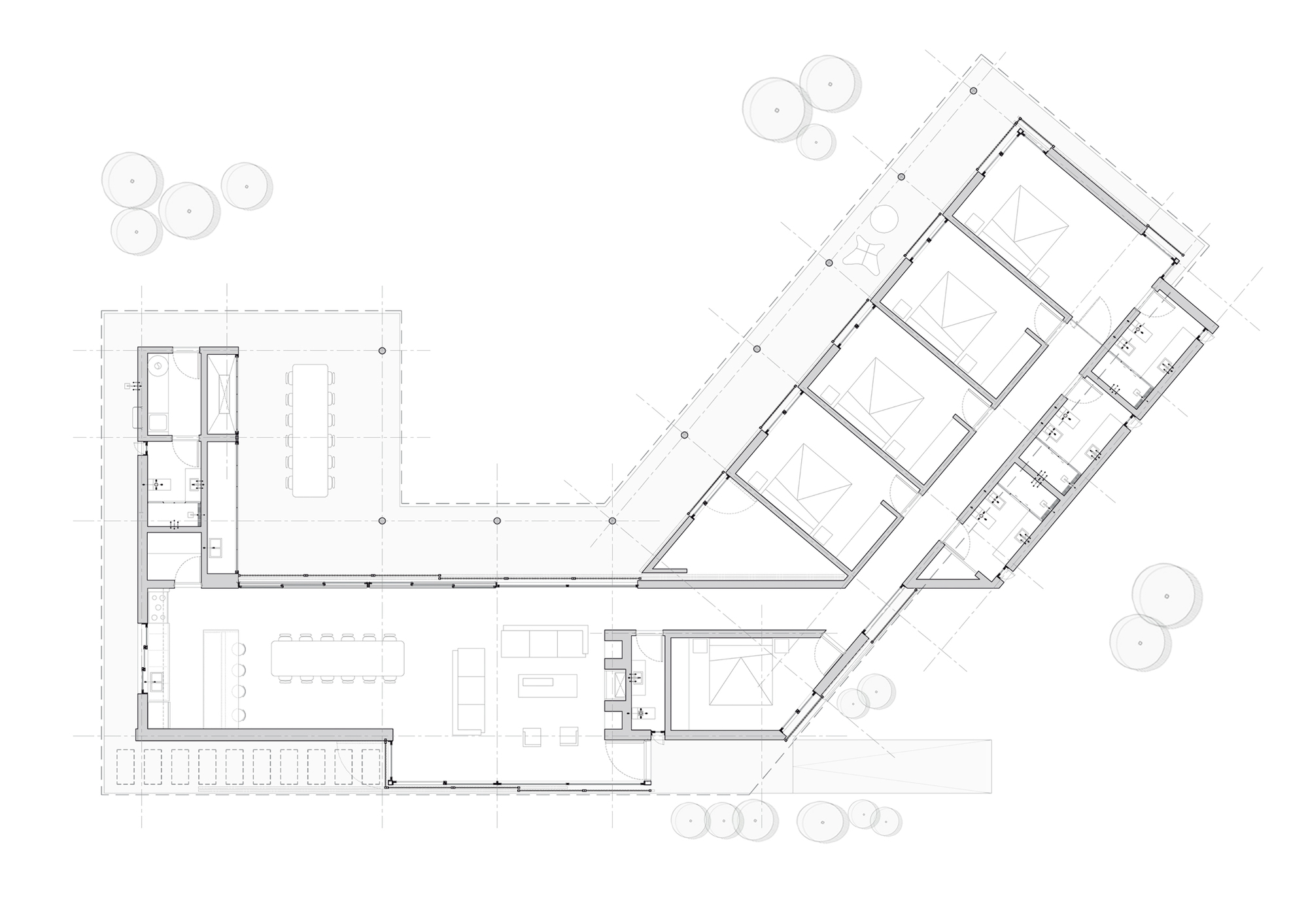 Floor plan drawing of an angled L-shaped house with a row of bedrooms along one wing and living and dining space in the other