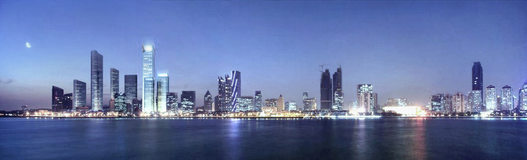 Panorama of a lit waterfront skyline across dark water under a blue twilight sky and a pale moon