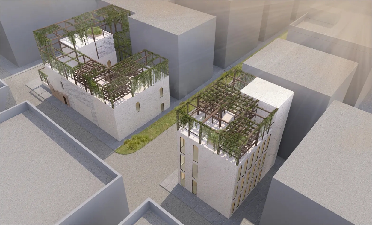 Aerial view of two white buildings with rooftop timber pergolas and hanging vines among grey neighbouring blocks in hazy light. Image: Sara Krzysztyniak
