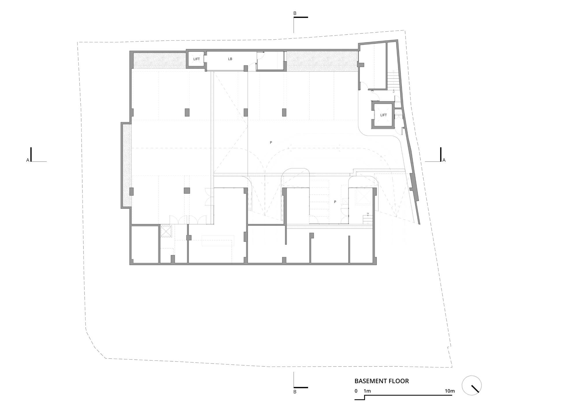 Basement floor plan drawing showing parking bays, structural columns, two lift cores and a stair along the angled site edge