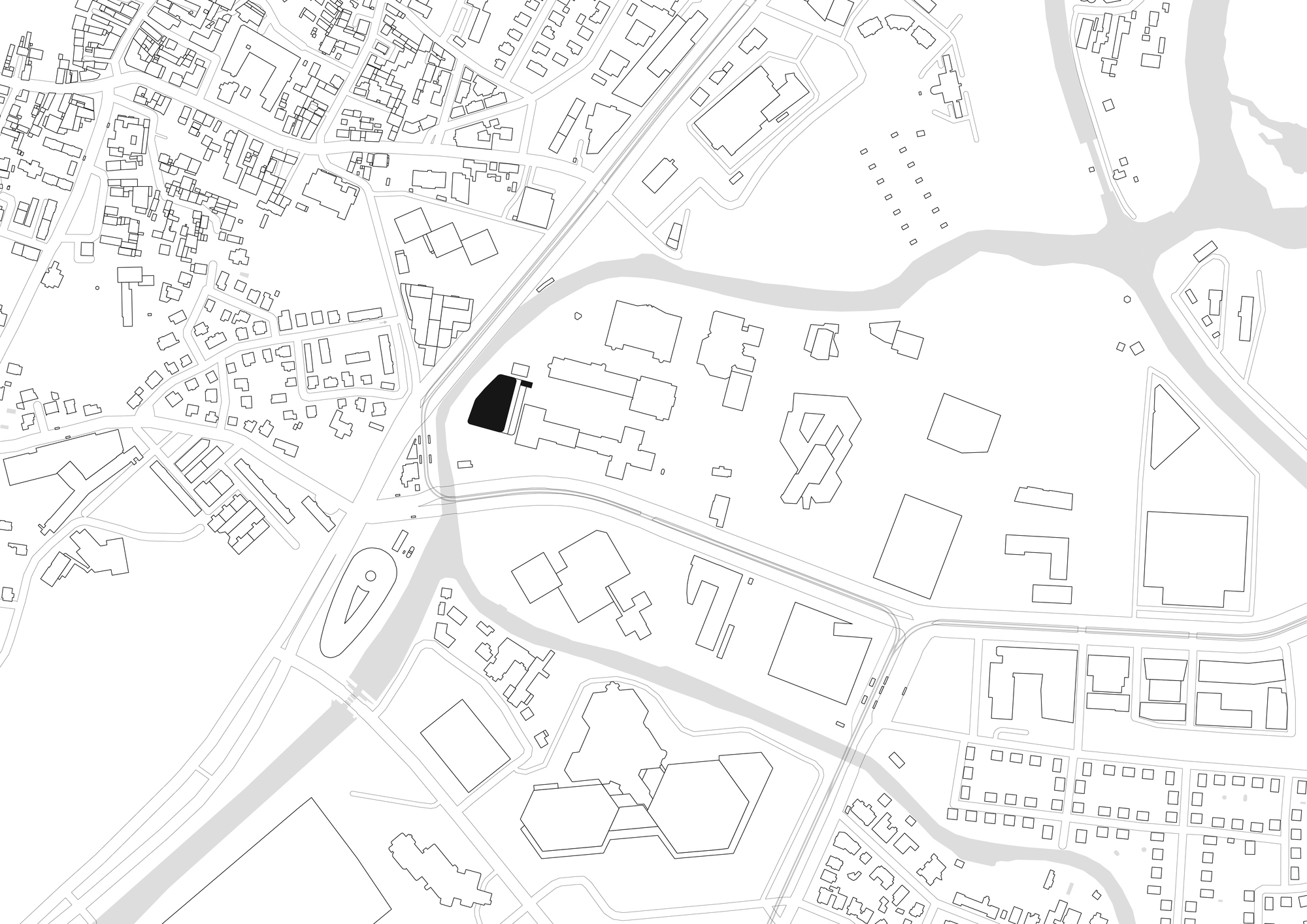 Site plan drawing showing one black building footprint beside a road, with surrounding blocks, rivers and streets in light line work
