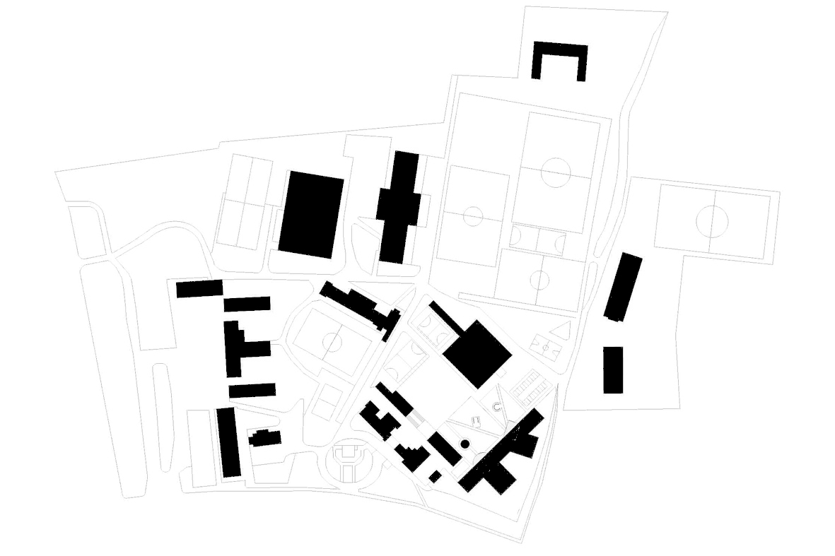 Site plan drawing showing building footprints in black among sports pitches and paths on a school campus