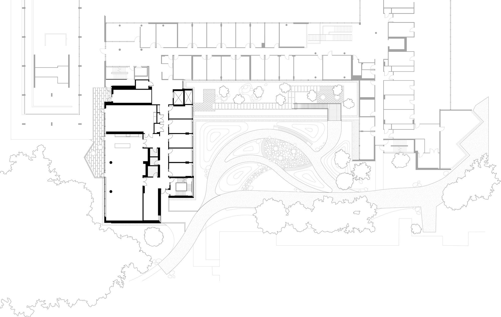 Ground floor plan drawing showing a bold-outlined building wing beside a curving landscaped courtyard and a sweeping path among tree canopies