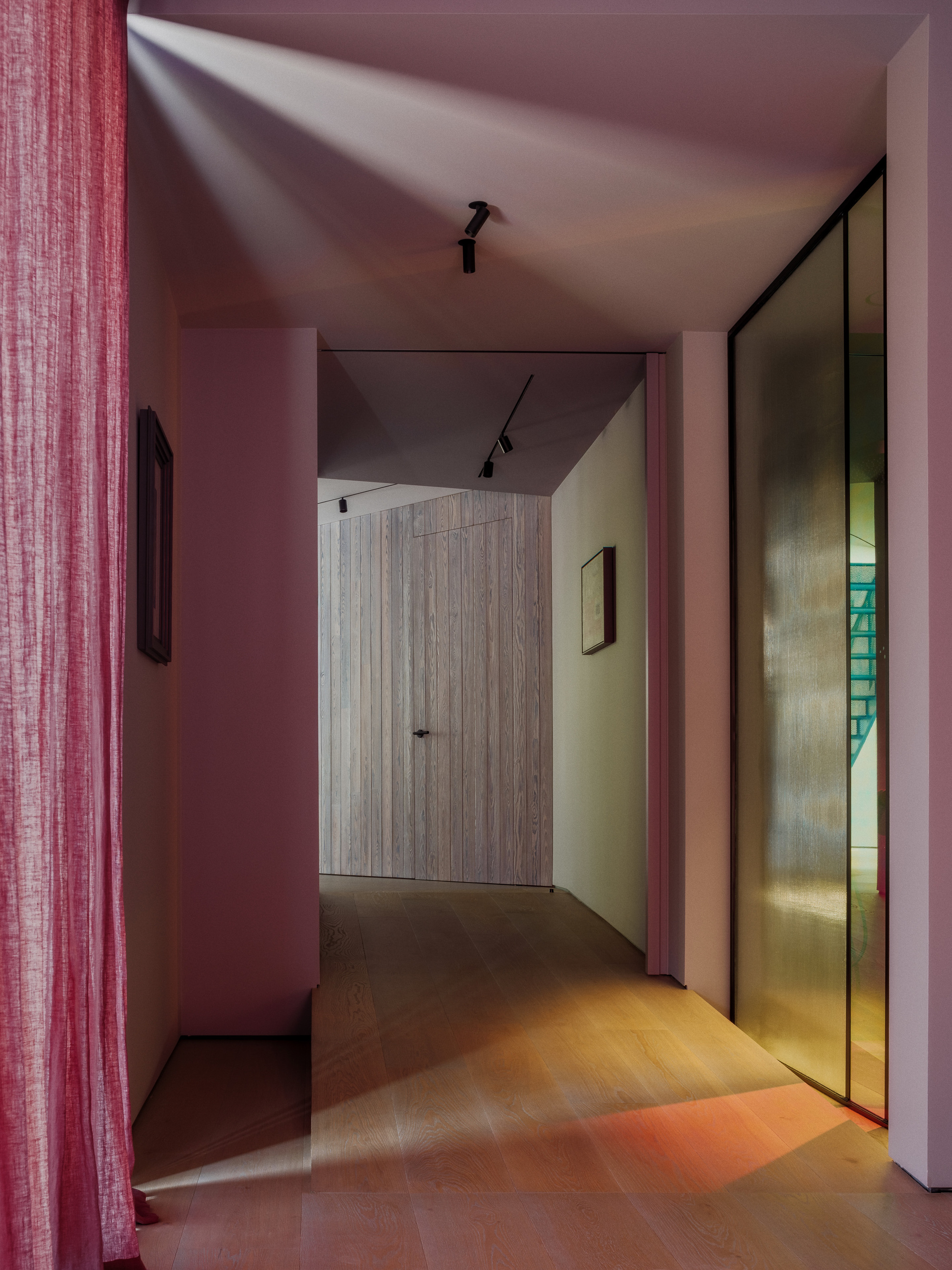 Hallway with oak floor and ribbed amber glass panel, a pink curtain at left and a timber door ahead