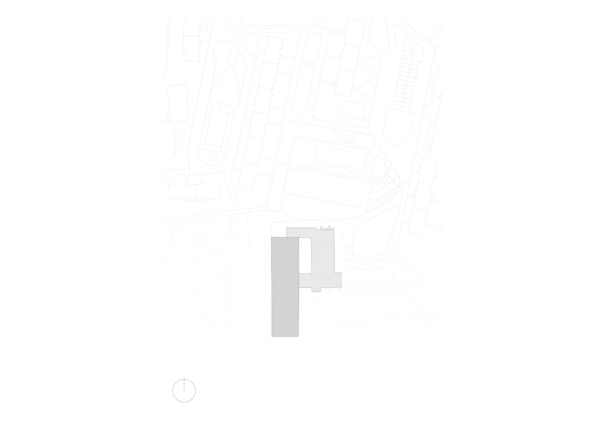 Site plan drawing showing the building footprint in grey, an L-shaped block and a long slab, within a faint street grid