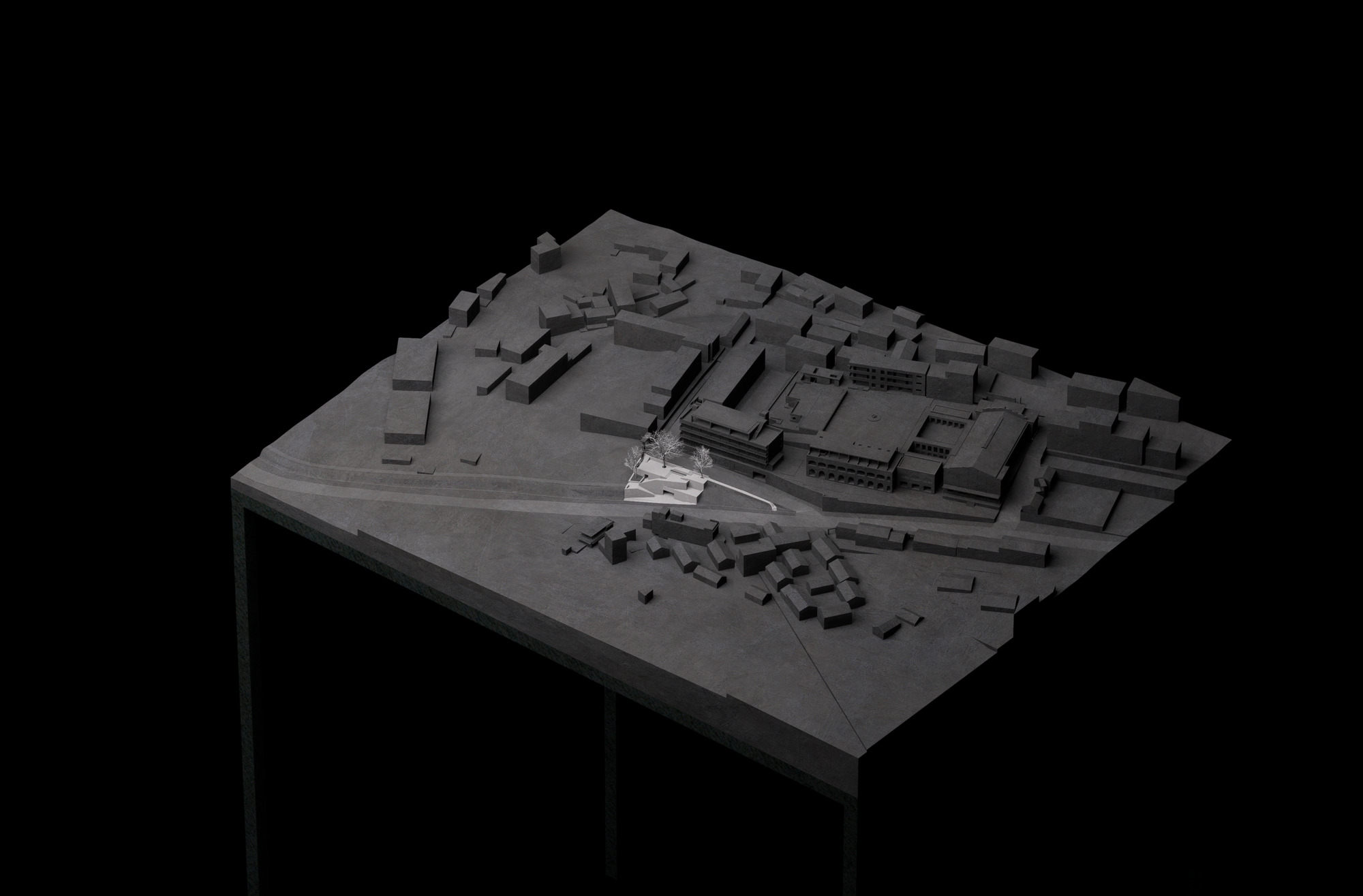 Dark site model of a town block on a plinth, with the small stepped structure picked out in white beside a road