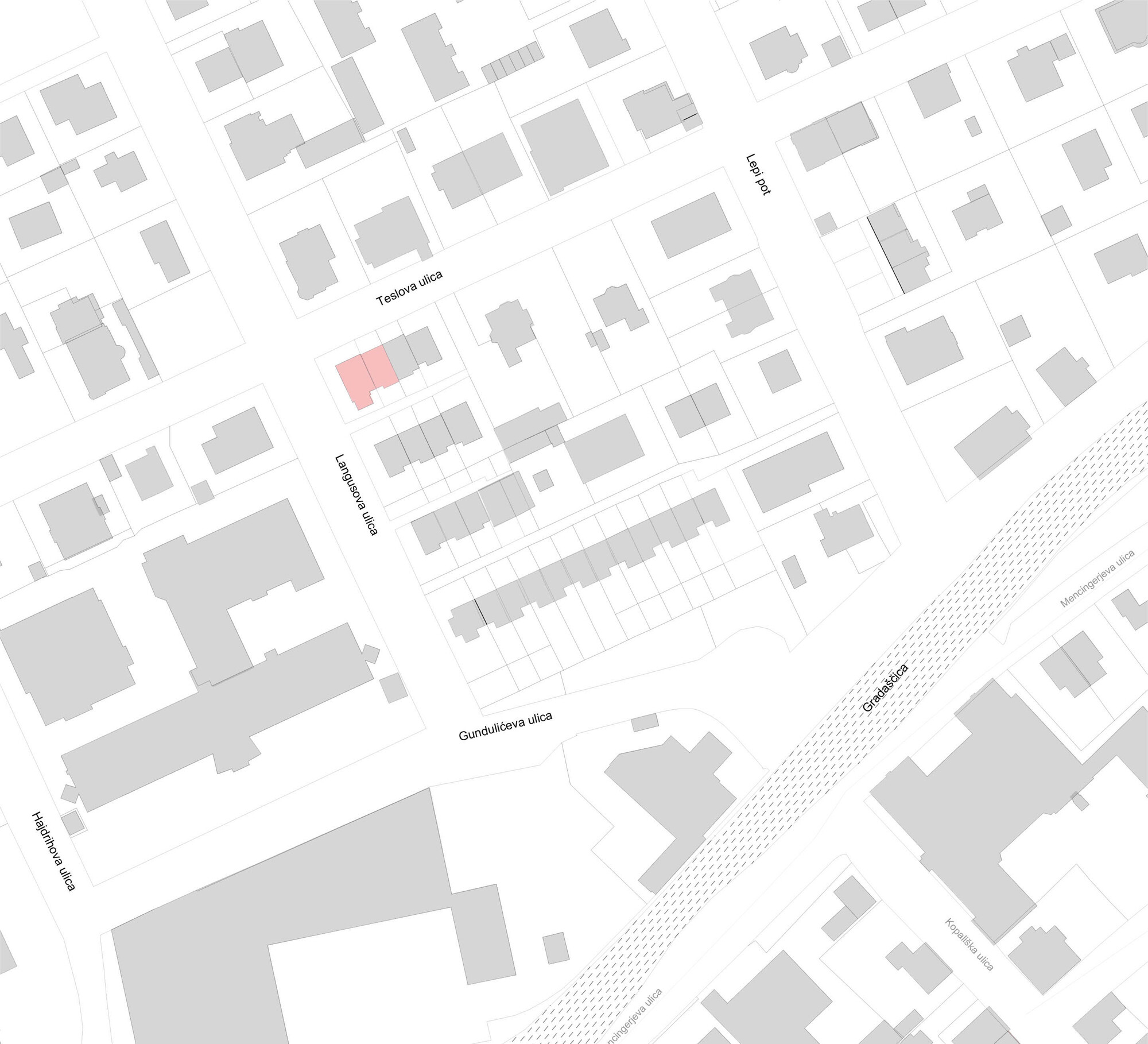 Site plan drawing of a street block with one highlighted corner building among grey rooftops, with a wide road cutting diagonally across the lower right