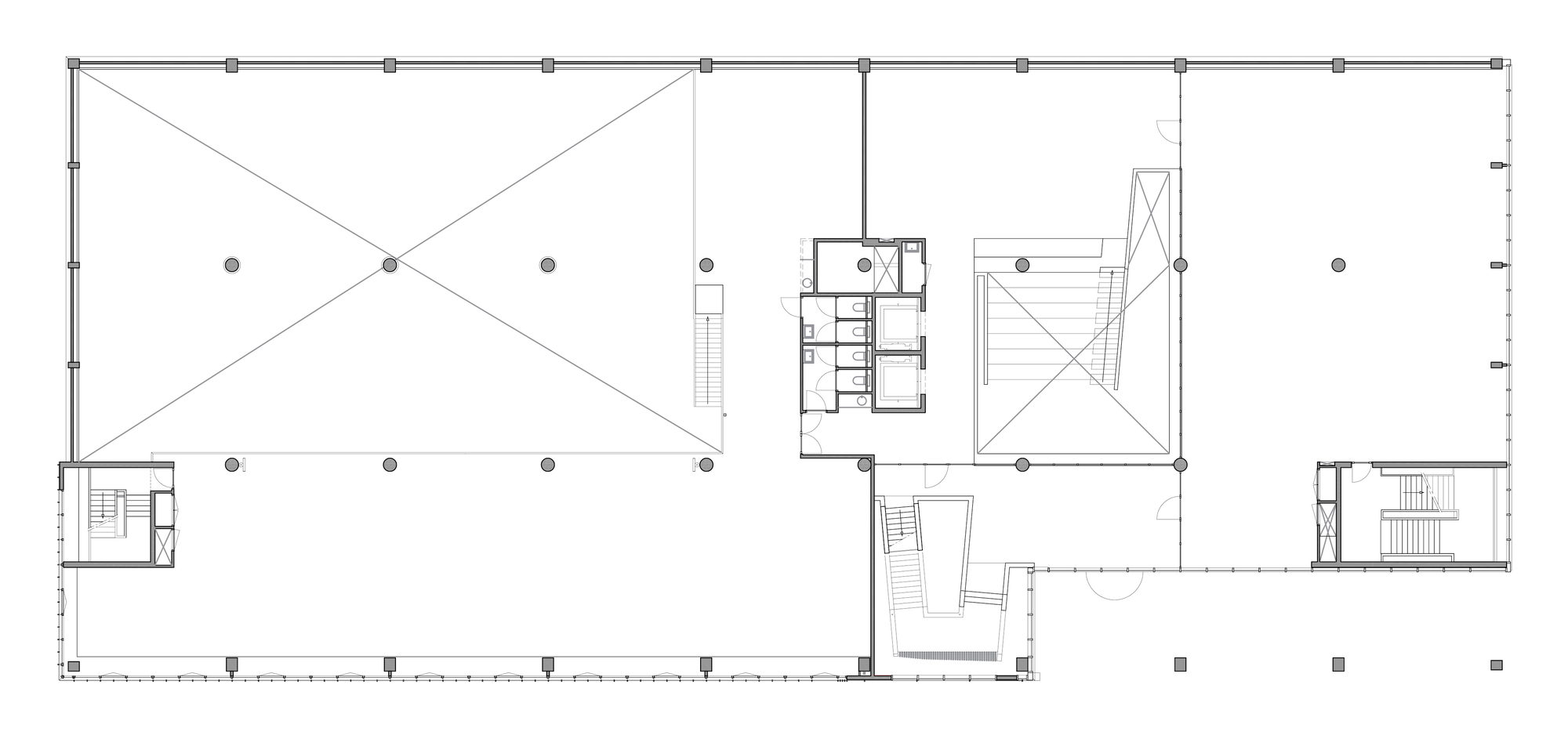 Floor plan drawing of an open upper level with a central service core, two stair towers and diagonal-crossed voids