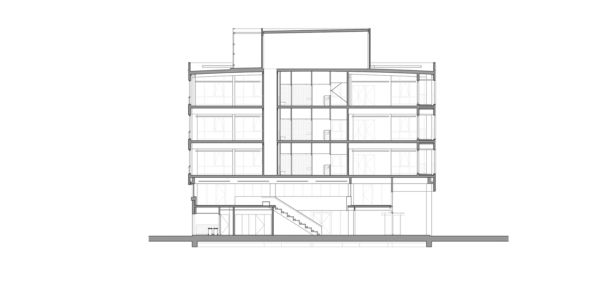 Building section drawing showing five levels, a central atrium, a rooftop volume and a stair descending to a basement