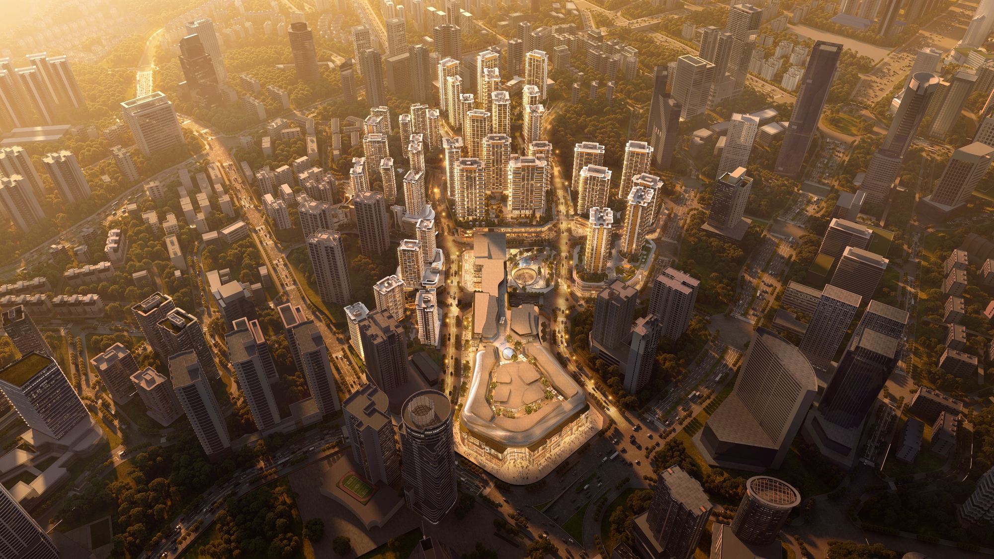 Aerial view of a dense tower cluster and a large rounded commercial podium in warm low sunset light