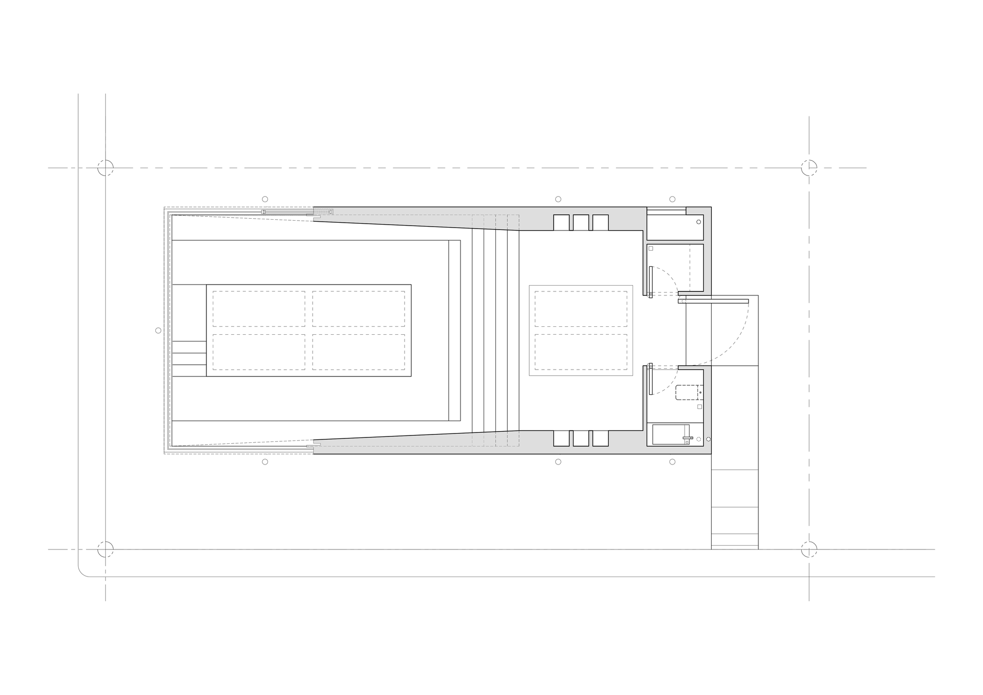 Floor plan drawing showing a narrow rectangular hall with tapering stepped seating, central voids and a small service block at the entrance
