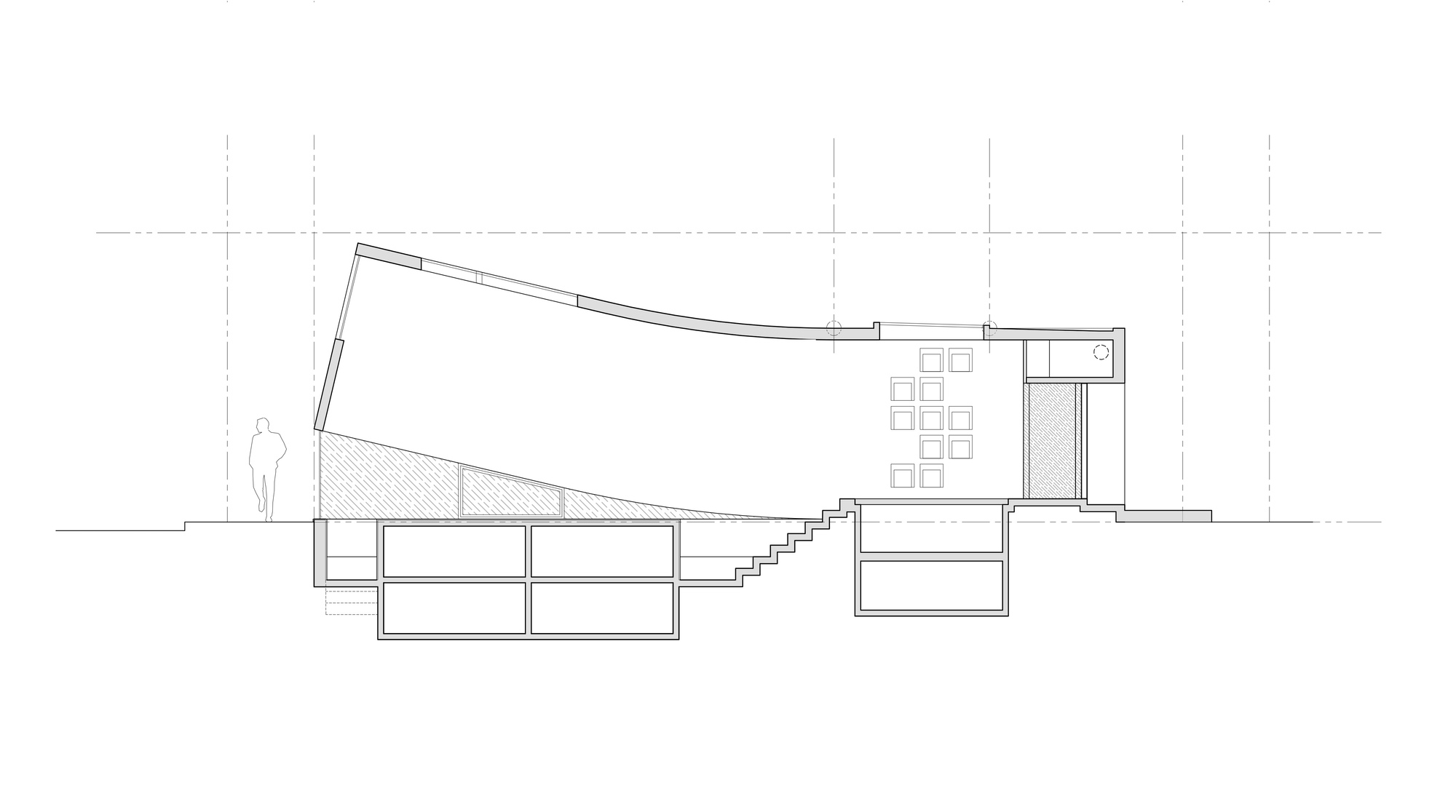 Section drawing showing a sloped, curving roof over stepped seating, with underground rooms below and a standing figure for scale