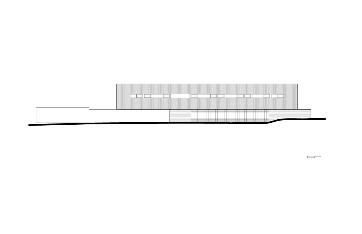 Elevation drawing of a long box volume with a ribbon of small windows above a base of tiled and plain walls