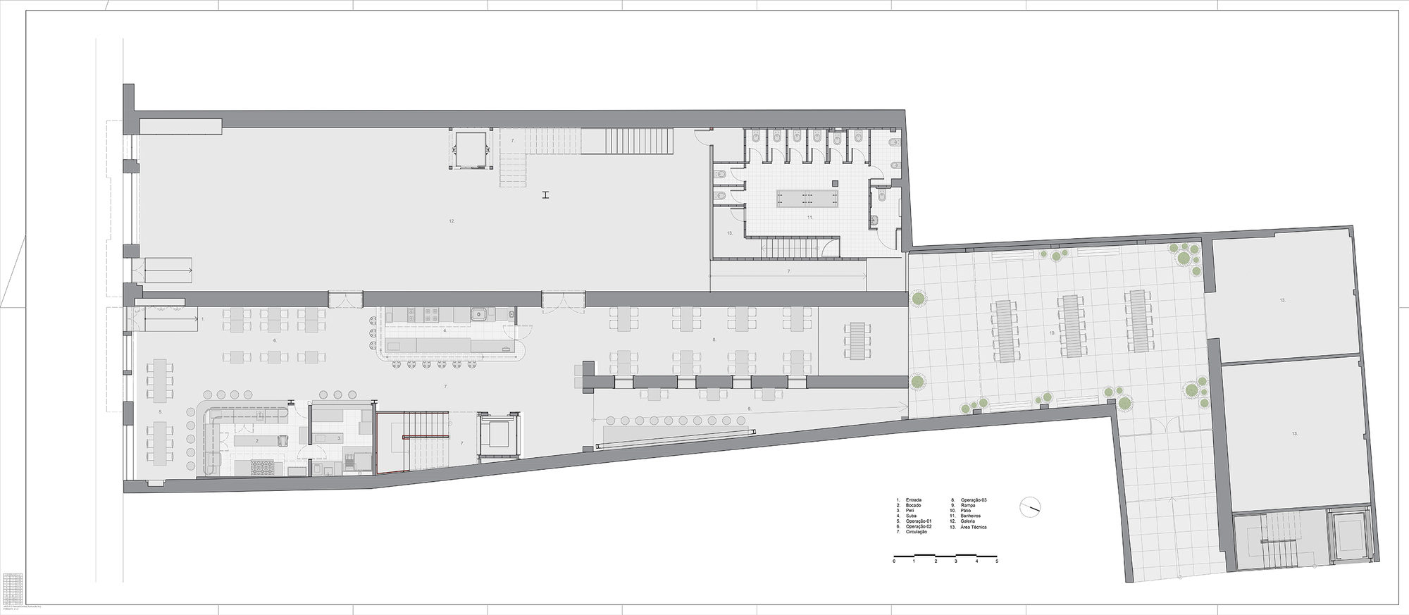 Ground floor plan drawing showing a long interior hall with kitchen and tables, restrooms, and a paved courtyard with long tables