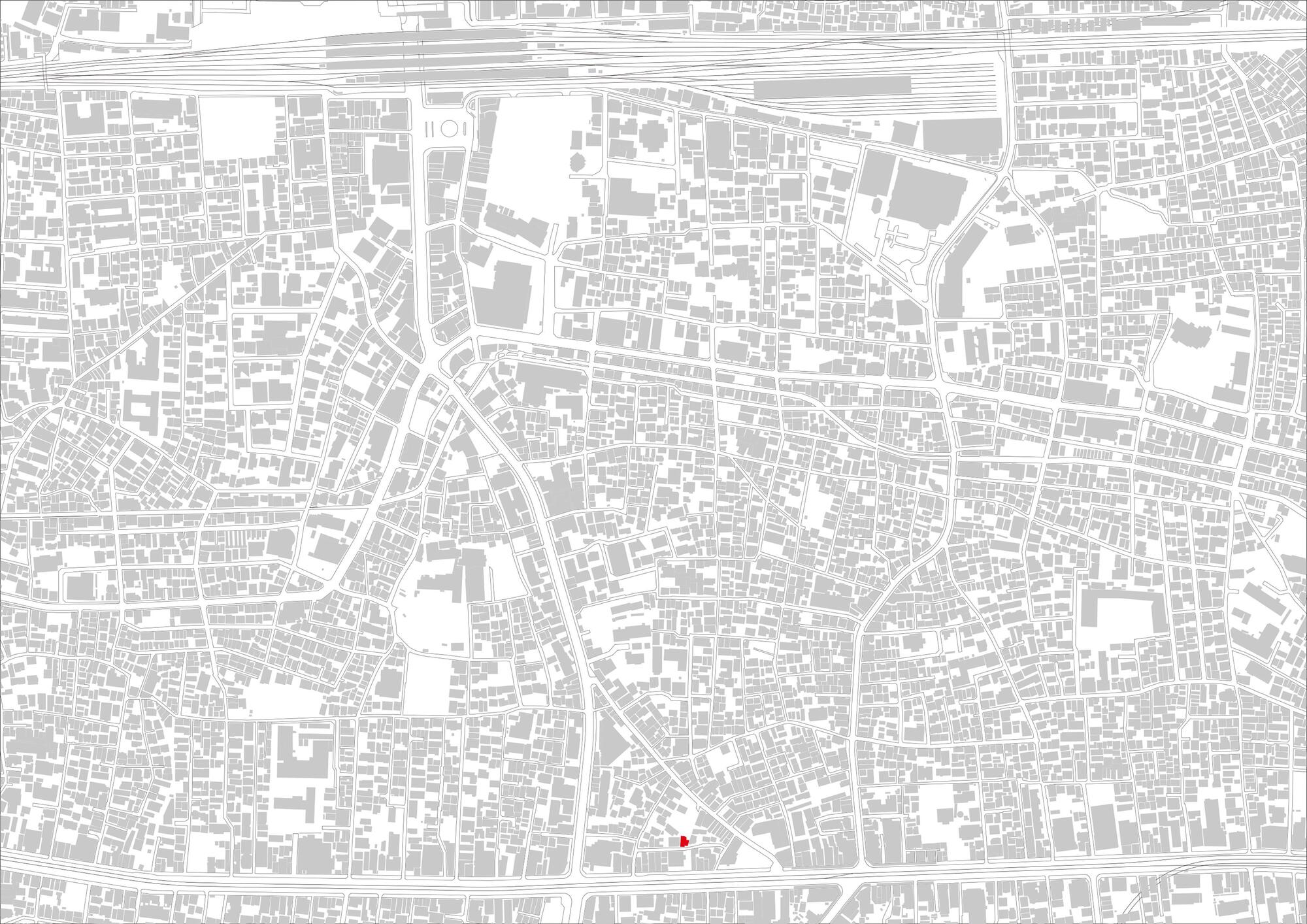 Site map drawing of a dense urban block of small buildings and streets with one footprint marked in red
