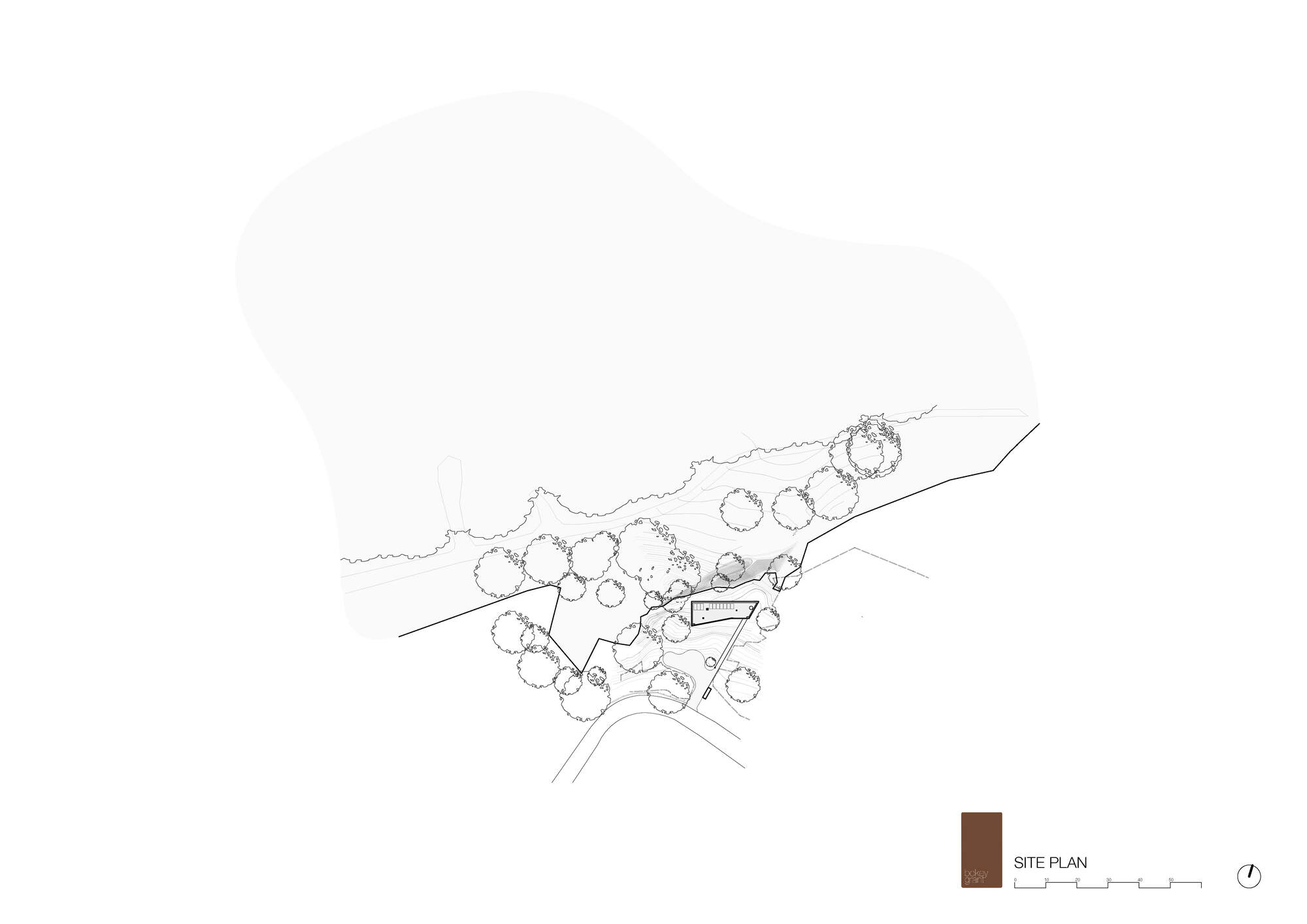 Site plan drawing showing the small building footprint among scattered trees along a curving boundary and a large open area above