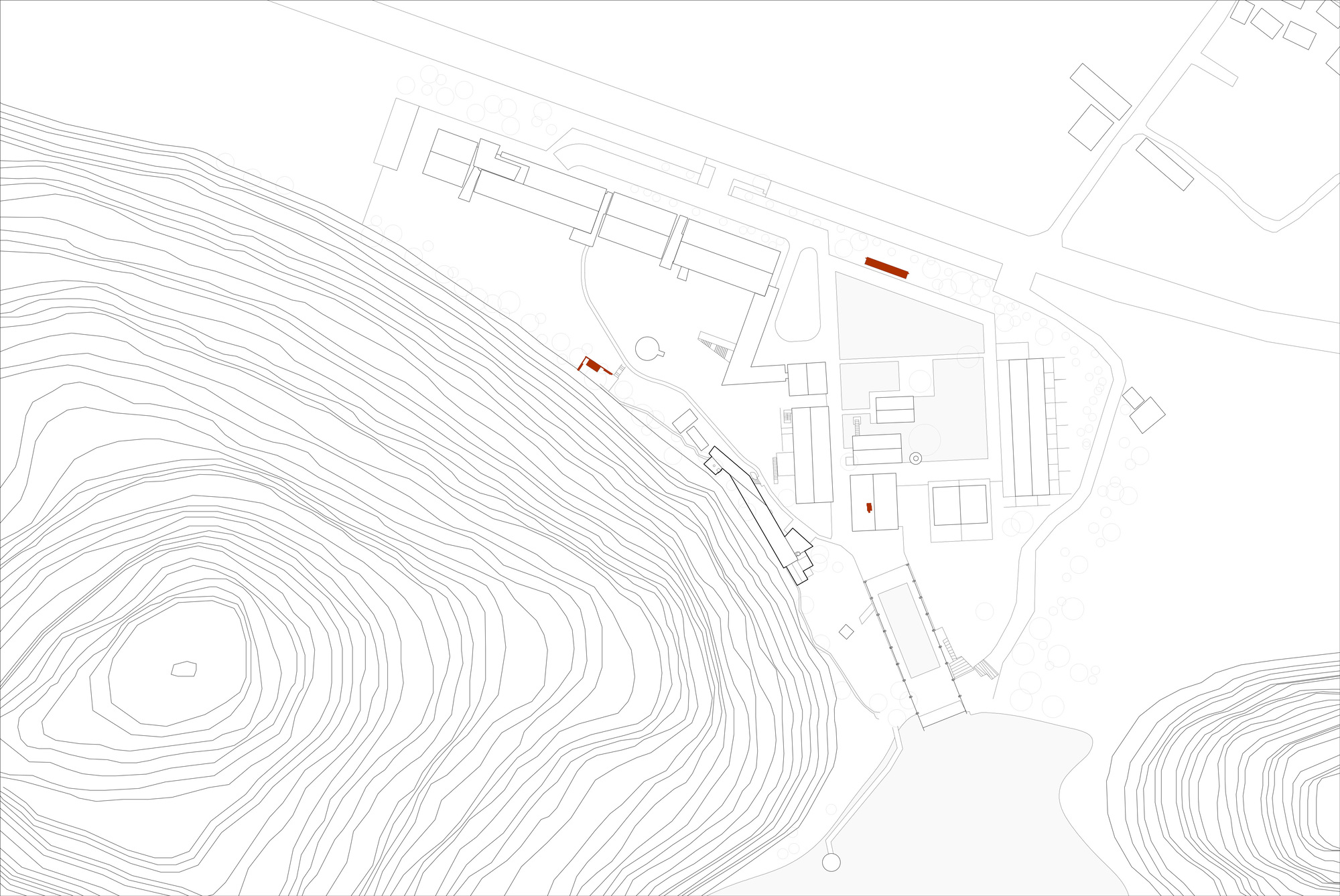 Site plan drawing showing building footprints along a road beside contour lines of a hill, with three small volumes marked in red