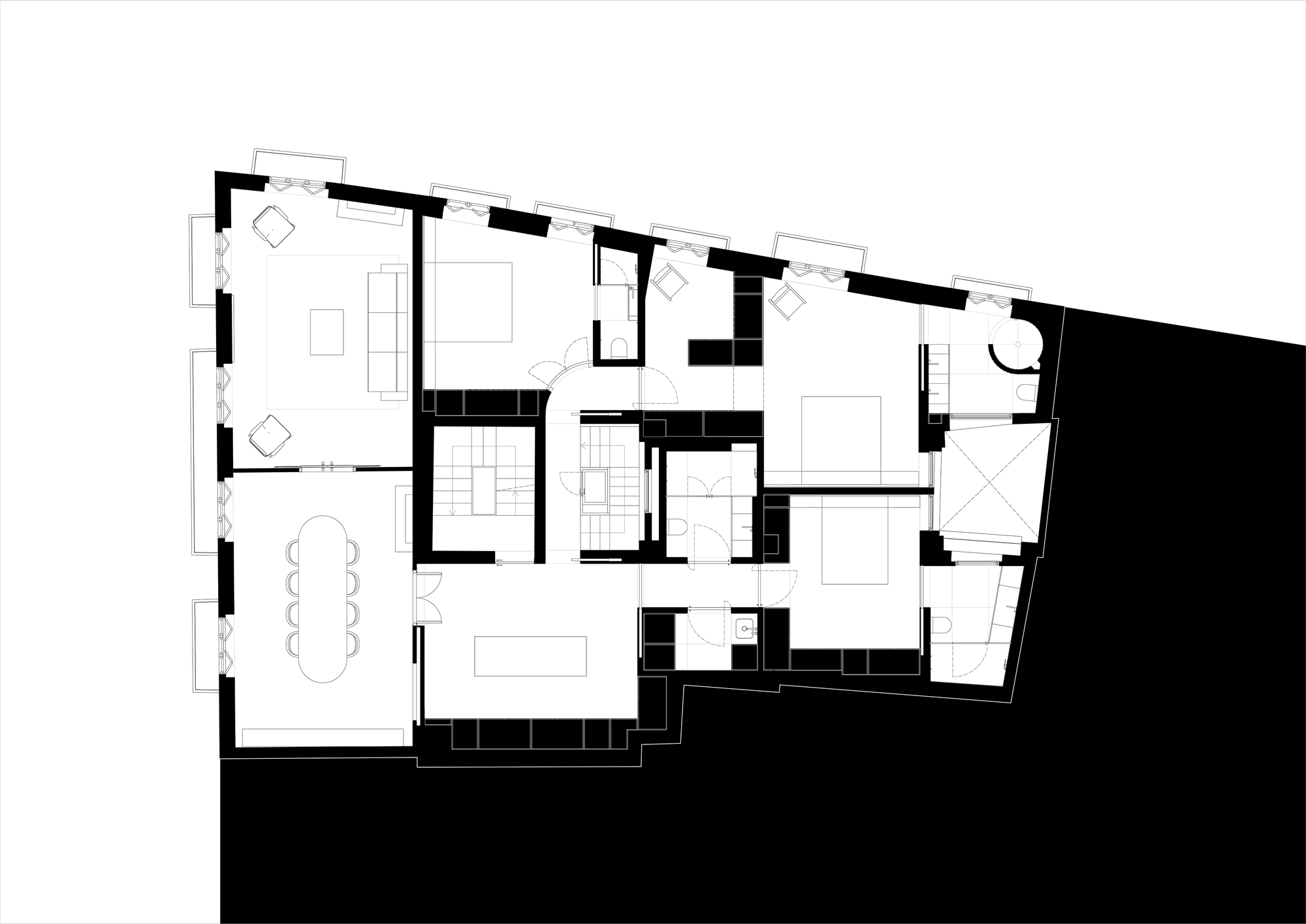 Floor plan drawing of an apartment with a dining room, living room, bedrooms and bathrooms arranged around a central stair core