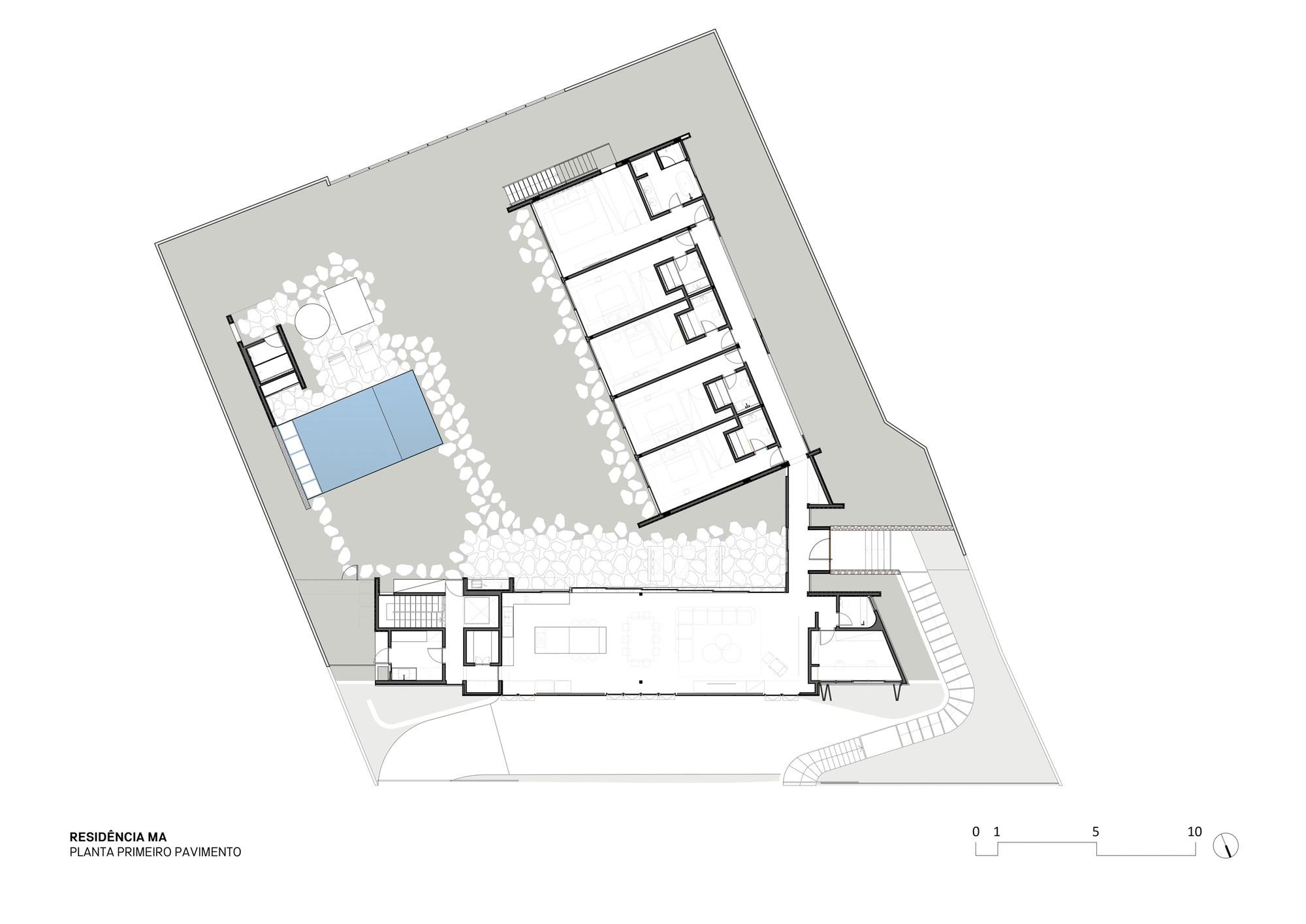 First floor plan drawing showing an L-shaped layout with a long living pavilion, a row of bedrooms and a pool framed by pebbles