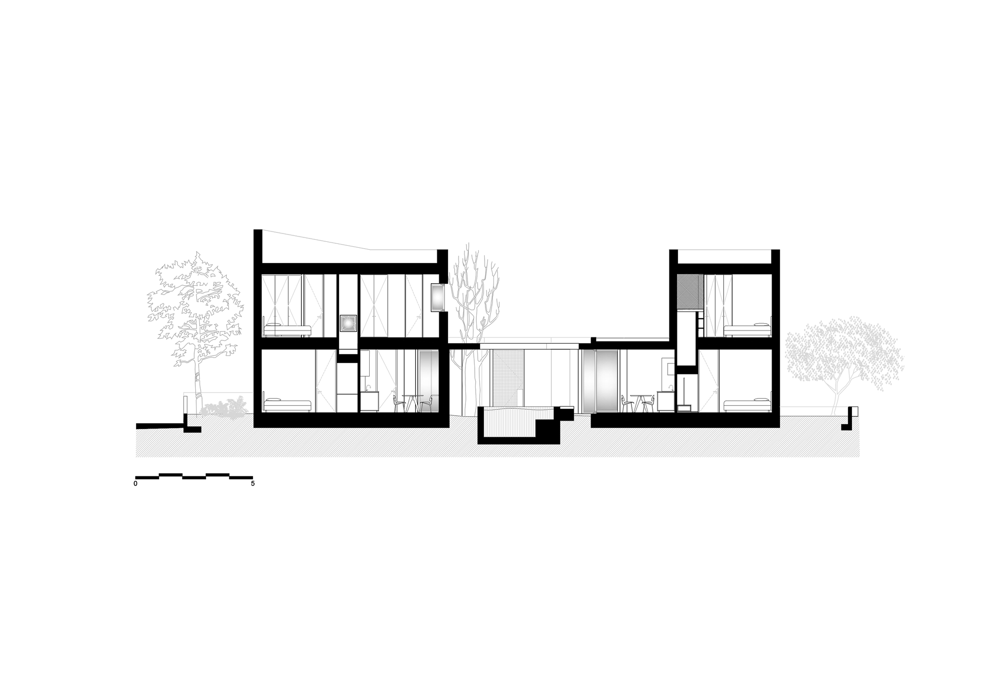 Section drawing cutting through two two-storey volumes either side of a sunken central courtyard, with bedrooms and living spaces shown beside bare trees