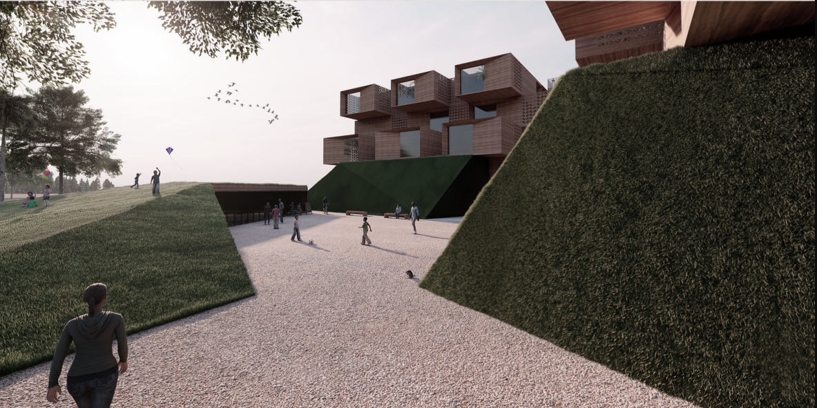 Gravel path between steep grass embankments leading toward the stacked timber volumes, with kite flyers and walkers on the lawn. Image: Katarzyna Skibińska, Justyna Kościółek