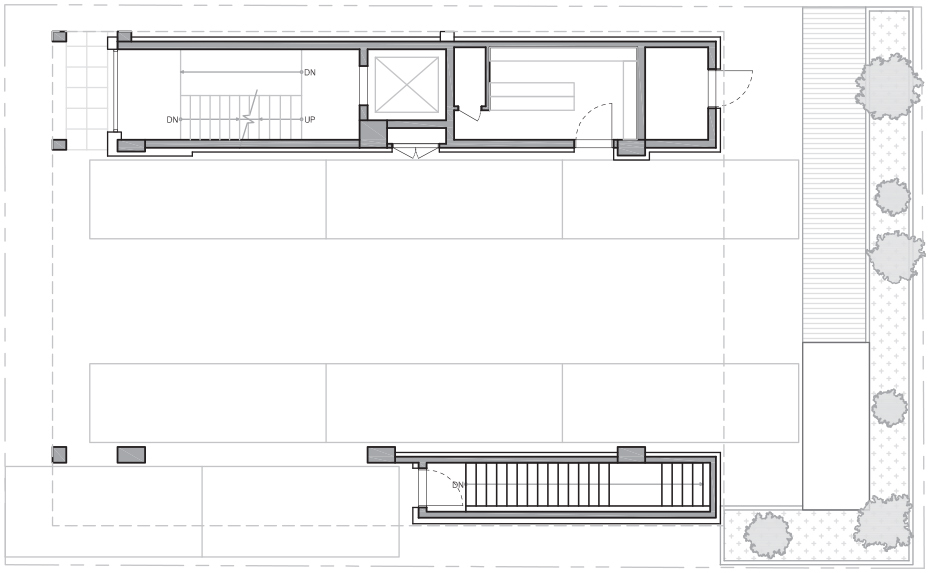 Floor plan drawing of a ground level with two stair cores, an elevator, open parking bays and a planted edge with trees