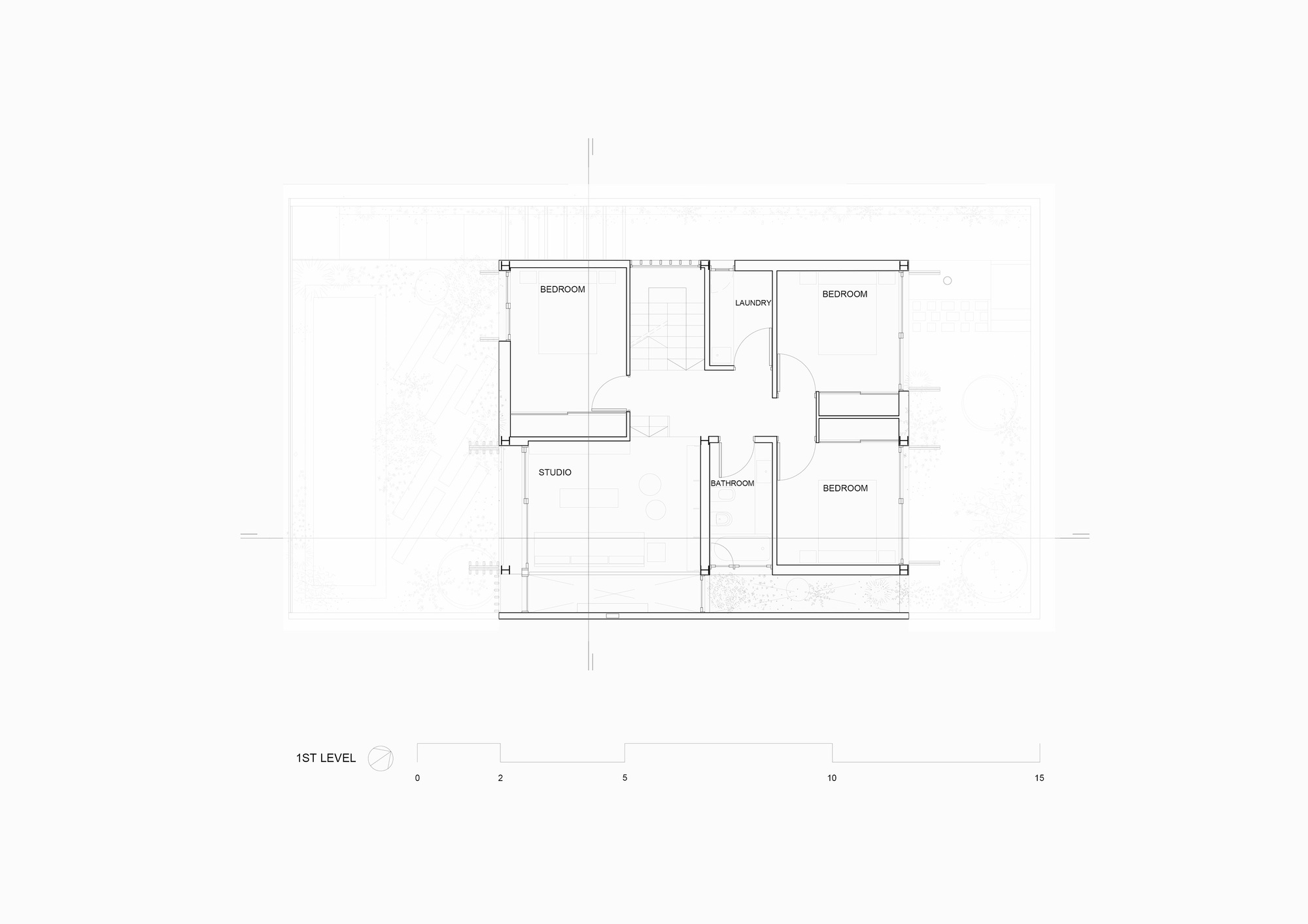 First level floor plan drawing showing three bedrooms, a studio, laundry and bathroom organized around a central stair and corridor