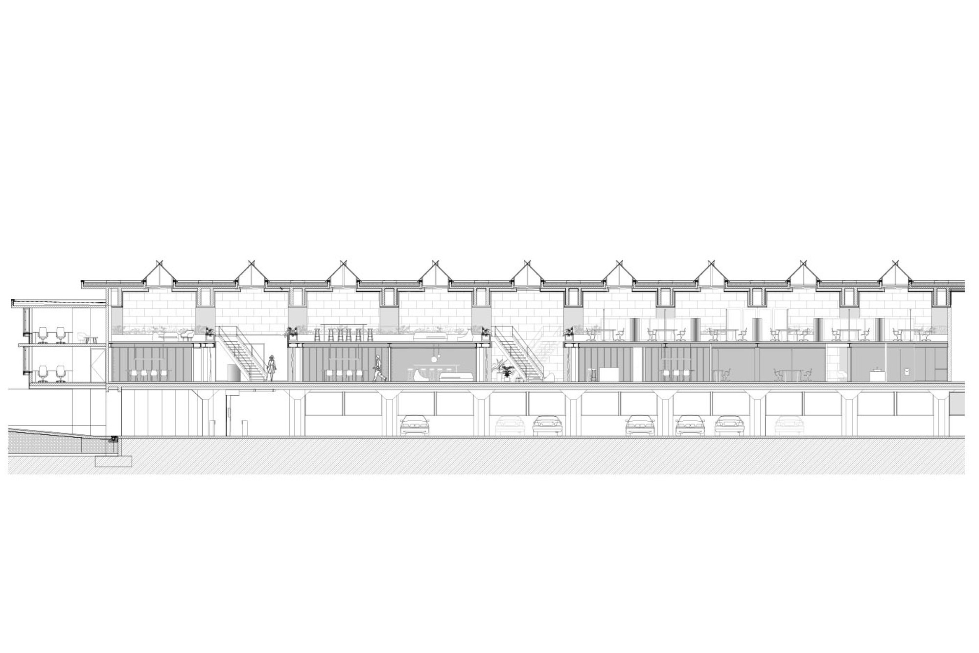 Long section drawing of a sawtooth-roofed office building with stairs, mezzanine volumes and parked cars in the undercroft below