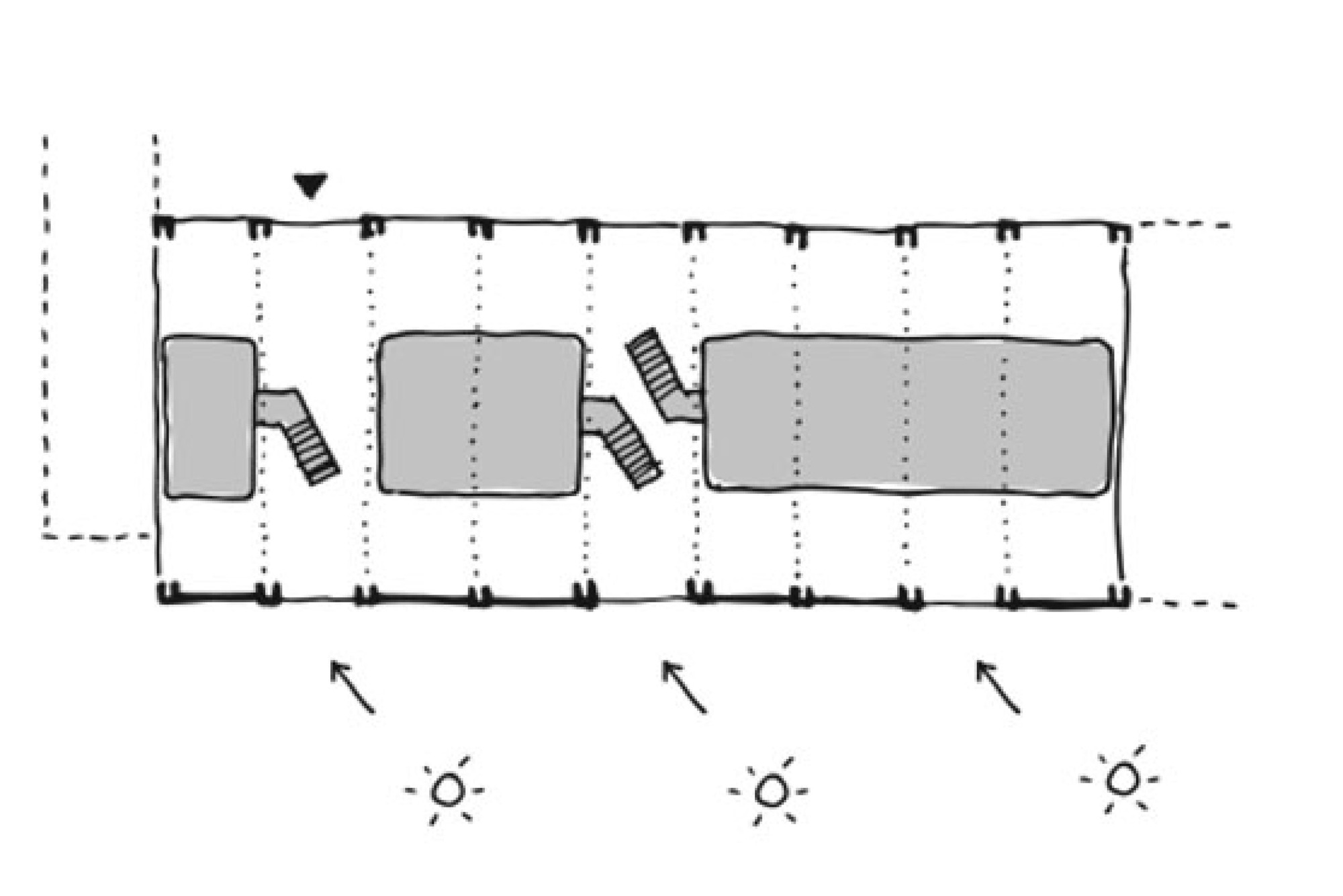 Plan sketch of a long rectangular bay with three grey volumes, two small stairs, a column grid and arrows marking sunlight from one side
