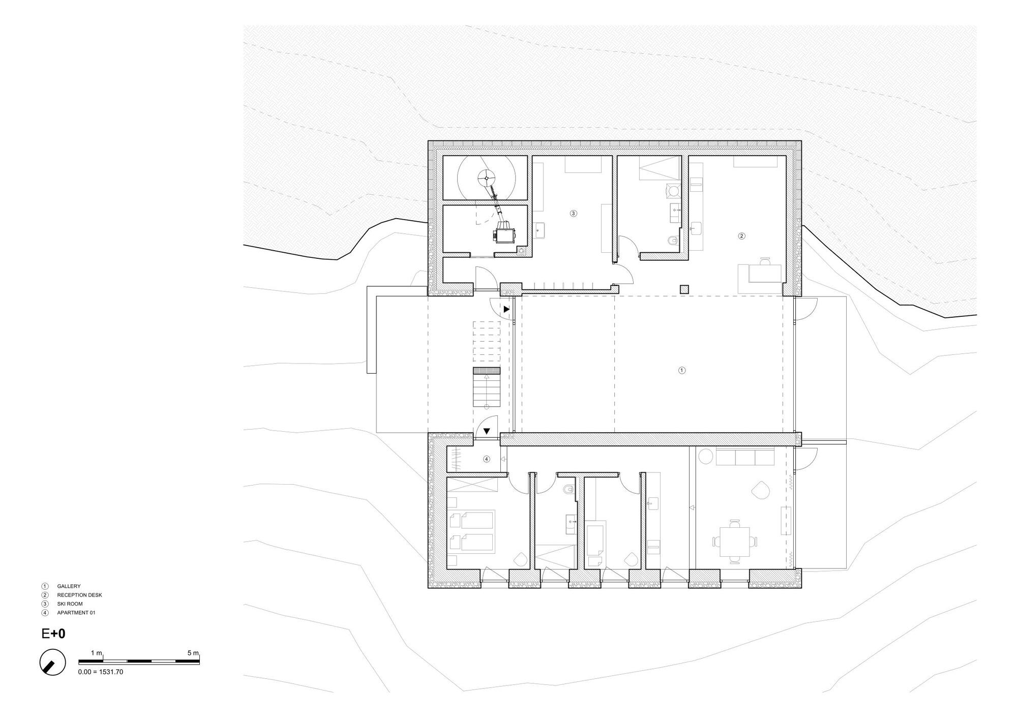 Ground floor plan drawing showing a central gallery, reception desk, ski room and an apartment arranged within thick stone walls on a sloping site
