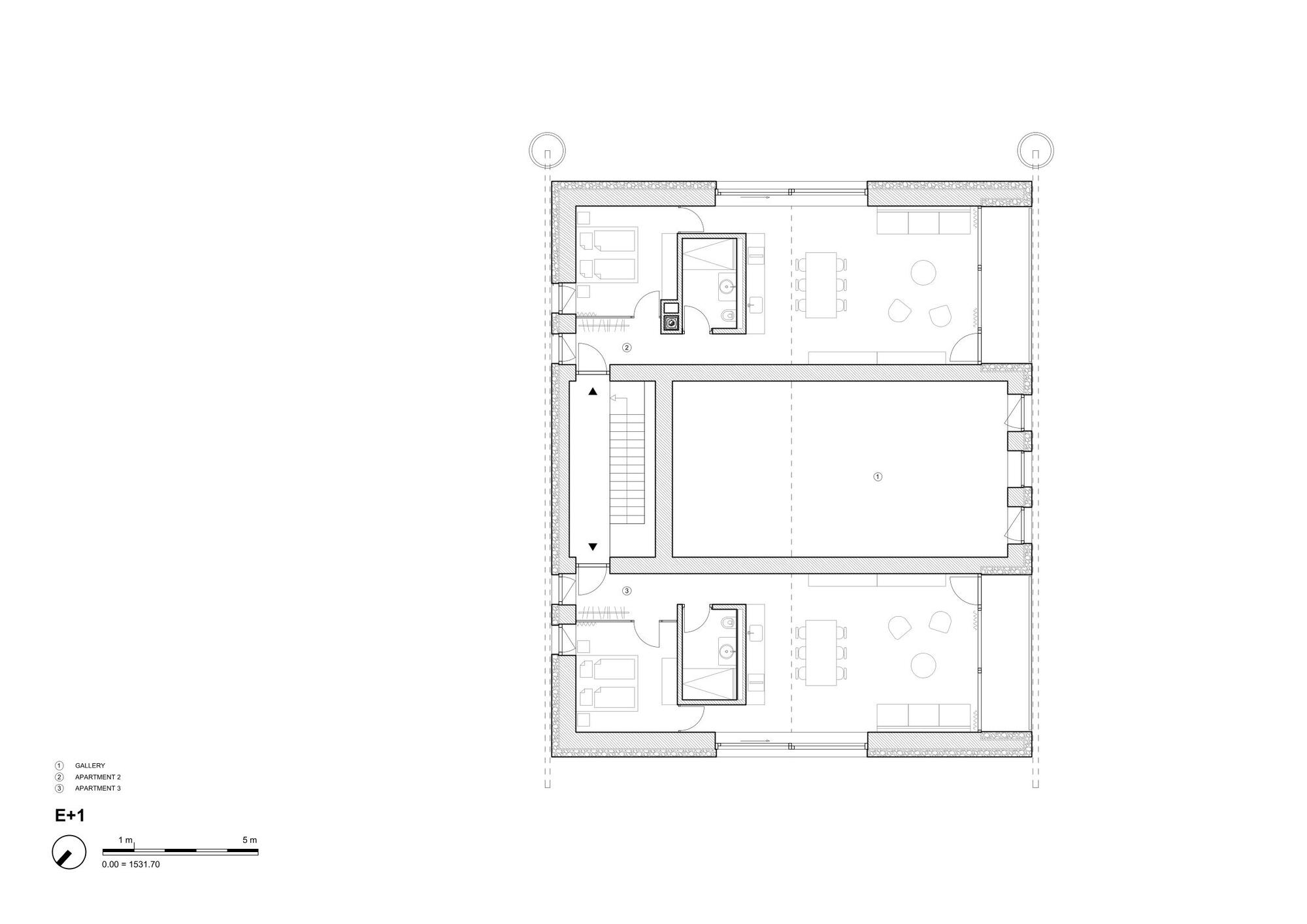 Upper floor plan drawing showing a central gallery void flanked by two apartments with bedrooms, bathroom cores and living areas on either side of a stair
