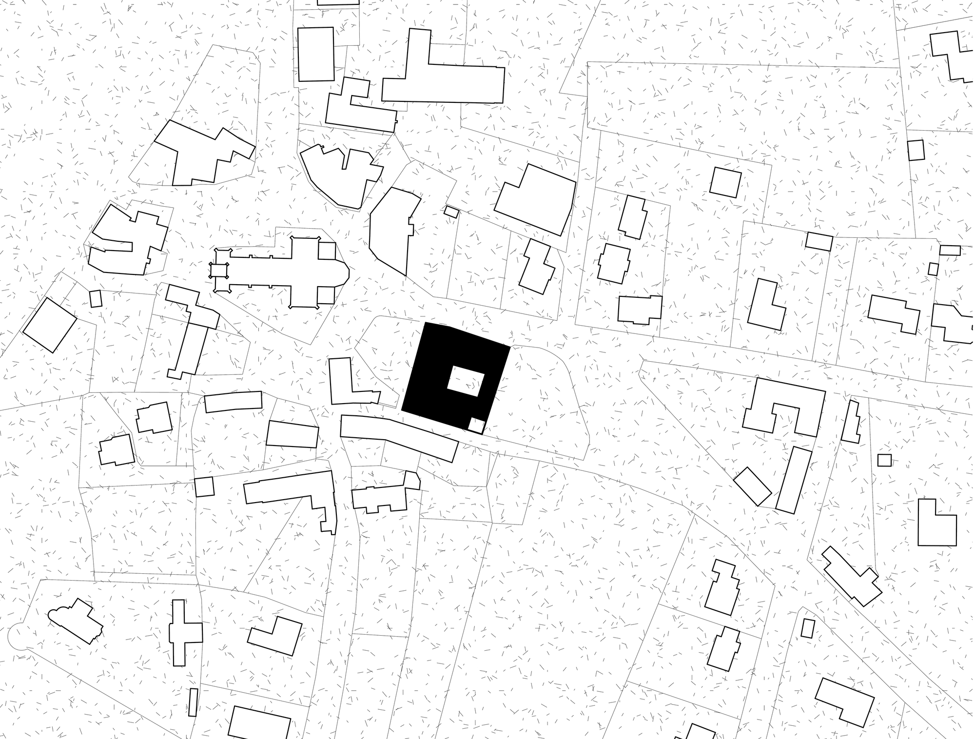 Site plan drawing showing the building footprint in solid black with a central courtyard, set among surrounding village buildings and a church